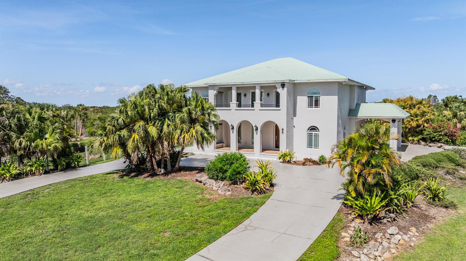 EXCLUSIVE ESTATE nestled in Rocky Point Preserve area of Tampa, offers a rare, 5-acre Park-like Setting, minutes from the airport, major highways, shopping and beaches!  PALM TREES & TROPICAL BREEZES add to the Expansive, SPECTACULAR views from second story breezeway, loft, cabana upper deck and most bedrooms in this sprawling 5543 square foot extraordinary, CUSTOM BUILT, Concrete block and stucco PRIVATE RESIDENCE!  Gated Entrance with Circular Drive, welcomes you to relax on your covered front porch with solar lit Tropical landscape!  Exquisite Solid Wooden Arched front entry door OPENS to Tile inlay floor accenting the dramatic Foyer between Spacious Formal Living & Dining Room, lit with Waterford Crystal Chandelier from England!  Architectural Details abound with ARCHES, NICHES, COLUMNS, Tray ceilings and GLEAMING GRANITE staircase with wrought iron & wood railings.  Heart of the home includes a palatial gathering room with SOARING ceilings, palladium windows and direct access to screened lanai, overlooking your heated POOL (newly installed pump 2023 & pool heater 2021).  Gourmet kitchen boasts Sub Zero refrigerator, Jenn-Air cooktop, Granite counters, breakfast bar, center island, solid wood raised panel cabinets, custom pantry and Miter window to take in the views.  Walk in Wine cooler being used as extra pantry.  Adjacent breakfast nook offers cathedral style ceilings and overlooks the pool!  Main level includes Formal areas, great room, powder room, under stair storage and Primary RETREAT with sitting area and spacious bath ensuite boasting double vanities, granite tops, jetted soaking tub, water closet and large shower.  Upstairs BONUS loft is great for game room/pool table with surround sound and lighted double tray ceiling.  Sound proof MEDIA room wired for surround sound with built in arched bookcases and French doors, next to the STEAM Shower in upstairs bath!  Guest bedrooms upstairs, with private bath ensuites, have walk in closets with closet organizers & turret bay window sitting areas with AMAZING views!  The front bedroom doubles as upstairs office with closet plumbed for additional bathroom.  2 car garage with painted floor has several windows for natural lighting, with CABANA roof top deck above with SUMMER KITCHEN boasting FABULOUS views of Tampa BAY and the bridges (gorgeous at nite), natural mangroves & causeway across the bay to Clearwater/Westshore area.  OUTDOOR LIVING is redefined here: a newly rescreened back porch (2023), a roof top cabana deck with summer kitchen, and sweeping views of Tampa Bay, the preserve, and cityscape.  A floating dock on the private canal provides fishing and bay access on paddle board/canoe, PLUS a new dock at the rear of the property!  Upgrades include METAL roof, hurricane-proof windows, newly painted exterior and driveway (2023), septic system (2019), mosquito spray system, water softener, instant-hot water, central vacuum, generator backup with propane hookup, six zone irrigation, landscape lighting, and pre-wiring for intercom.  Nestled on a quiet dead-end street within a wildlife sanctuary that is home to eagles, osprey, herons, and flat-billed ducks, this distinguished Tampa Bay estate offers seamless accessibility to St. Pete, South Tampa, airports, shopping, and beaches.  ALL THIS in a GREAT LOCATION, with no deed restrictions and NO CDD or HOA fees!  For your private tour and to make this Estate yours in Sunny Florida... CALL TODAY!