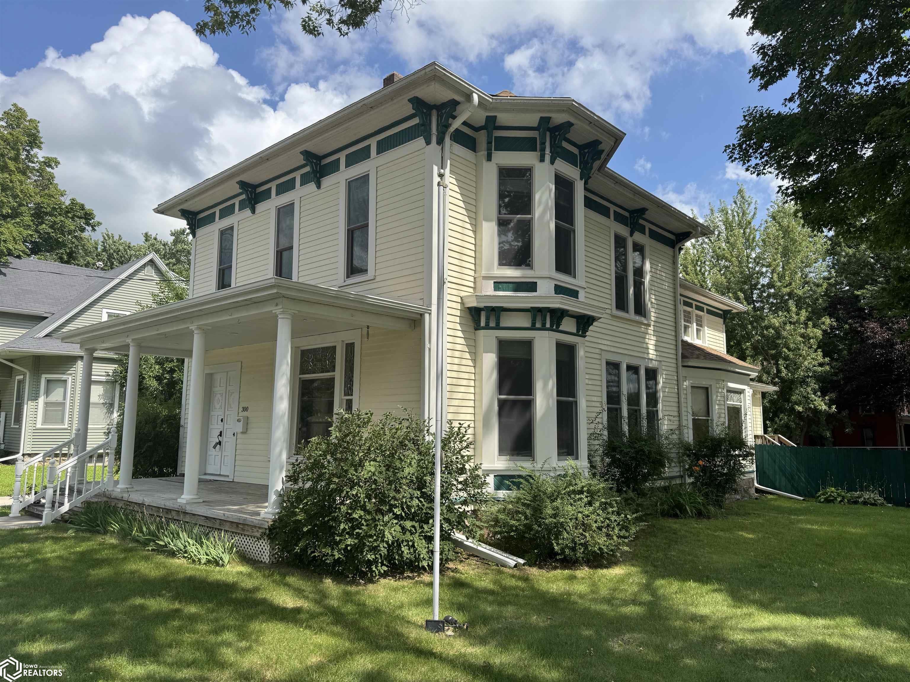 You may have passed by this beauty before, but you've never seen her like this!  All dressed up to show off her best features and PRICED in line with today's market.  If you love old homes this is a must see!  From the ornate original mantle, the marble clad bathrooms featuring a one of a kind cast-iron tub from the 1800's, not one but TWO sets of functioning pocket doors, MILE HIGH ceilings, custom banister, leaded glass and stained glass windows (the rest are tip-in efficiency replacements) well-appointed kitchen with new cabinets and solid surface countertops to roll out all your cookies, hardwood floors throughout, many built-ins and loads of charm.  If you're a front porch sitter, she's got one....and it's a beauty.  Rather sit on the back deck and overlook your fenced yard and triple garage?.......well - she's got that too! OLD HOME LOVERS - YOU WON'T FIND MORE HOME IN BETTER CONDITION FOR THE MONEY!   And the location?  You can get EVERYWHERE from here.  Just a few blocks from the heart of downtown.  Call today and make this gem your own!
