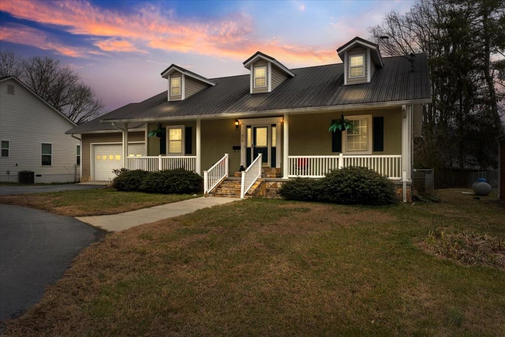 Welcome home to the heart of beautiful downtown Murphy, NC! This charming property offers the perfect blend of convenience, comfort, and mountain-town living — all within city limits.  You'll love being just minutes from local schools, the scenic Riverwalk, the fitness center, and both tennis and pickleball courts. Whether you're enjoying a peaceful stroll by the water or an afternoon match with friends, everything you need is right at your fingertips.  Step inside and discover a thoughtfully designed layout featuring a formal dining room perfect for hosting holiday meals and gatherings, along with a spacious kitchen offering plenty of room to cook, entertain, and create memories. A separate office provides the ideal work-from-home setup, while a dedicated laundry room adds everyday convenience.  The inviting living room is anchored by a beautiful gas log fireplace, creating a warm and cozy atmosphere for relaxing evenings.  Need space? This home delivers with a HUGE mostly finished basement — perfect for a game room, home gym, guest suite, hobby space, or all of the above! Finish it out to your liking! There is also a climate-controlled storage room in the attached garage, keeping your belongings protected year-round.  Step outside and enjoy peaceful mornings or cool mountain evenings on the screened porches, ideal for soaking in the fresh air without the bugs. And your fur babies will love the huge fenced yard with plenty of room to run and play.  If you've been searching for in-town convenience with space, charm, and versatility, this one truly checks all the boxes. Come experience why so many are proud to call Murphy home! ***See the attached floor plan notes for spaces not included in the square footage*** Buyer's agent to verify square footage.