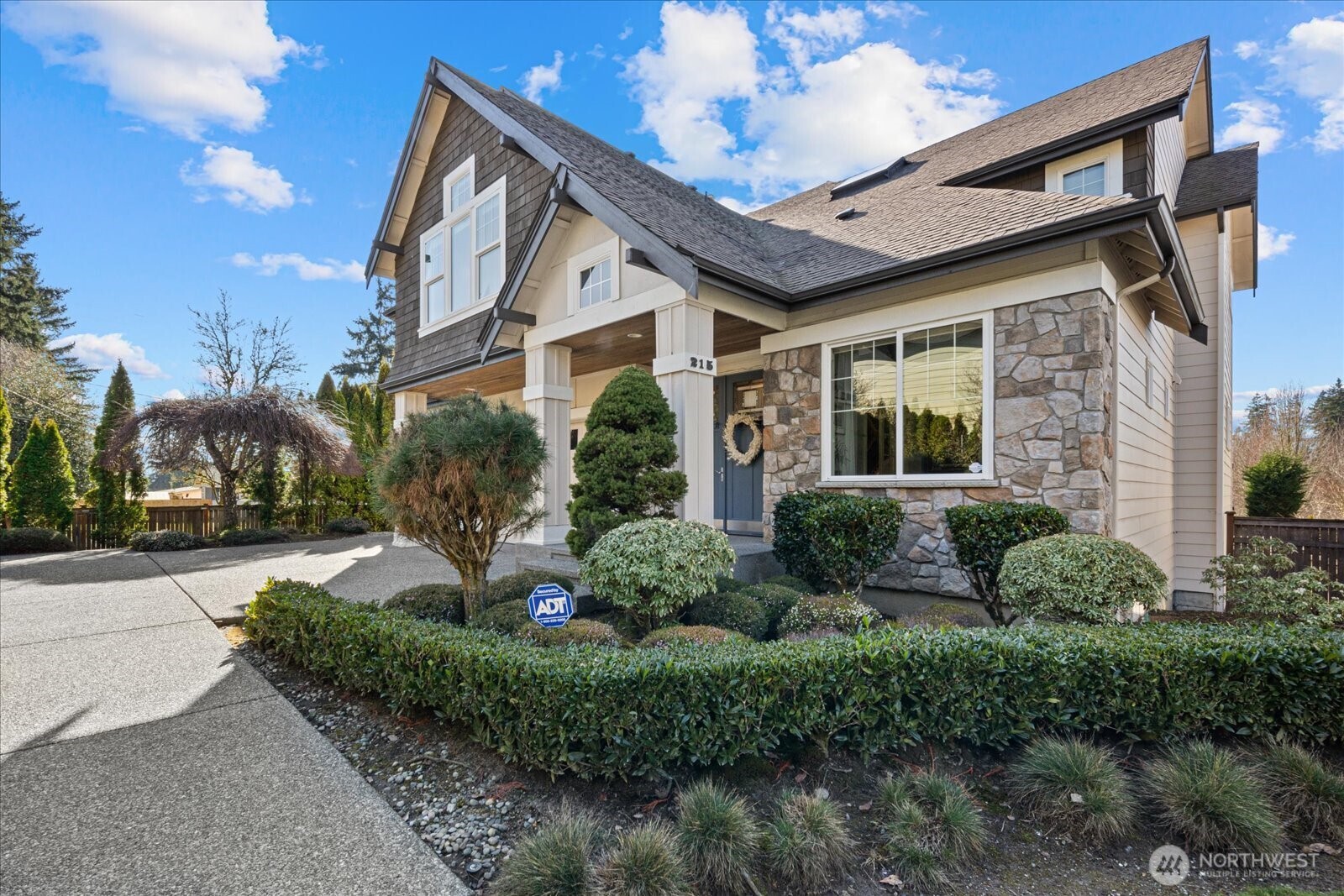 Set across three thoughtfully designed levels, this 6-bedroom, 3.75-bath luxury home delivers a rare blend of refined finishes, flexible spaces, and true privacy. The chef’s kitchen showcases premium Dacor and Bosch appliances, two full convection ovens, slab granite countertops, and a dry bar, all opening to an expansive Great Room designed for entertaining. Just off the kitchen, a covered patio extends the living space outdoors year-round. A hidden bonus room behind a secret door offers a distinctive retreat ideal for a whiskey room, collector’s space, or storage. The owner’s suite is a private sanctuary with a spa-inspired bath and oversized custom walk-in closet by California Closets. The fully finished lower level features a game room, recreation area, wet bar, and private bedroom with kitchenette, creating an excellent setup for guests, multigenerational living, or a potential mother-in-law suite. A main-level den provides flexibility as a 6th bedroom, while an upstairs bonus/media room adds more usable space. Double-paned, argon-filled windows enhance comfort and energy efficiency throughout the seasons, and central A/C keeps every level cool in summer. The three-car garage has wall-to-wall matting and an EV charger. Outdoors, the fully fenced private yard offers raised garden beds and privacy, relaxation, and outdoor living. Enjoy convenient access to Seattle, Bellevue, Sea-Tac, and Southcenter. Location allows enrollement in Bellevue Schools