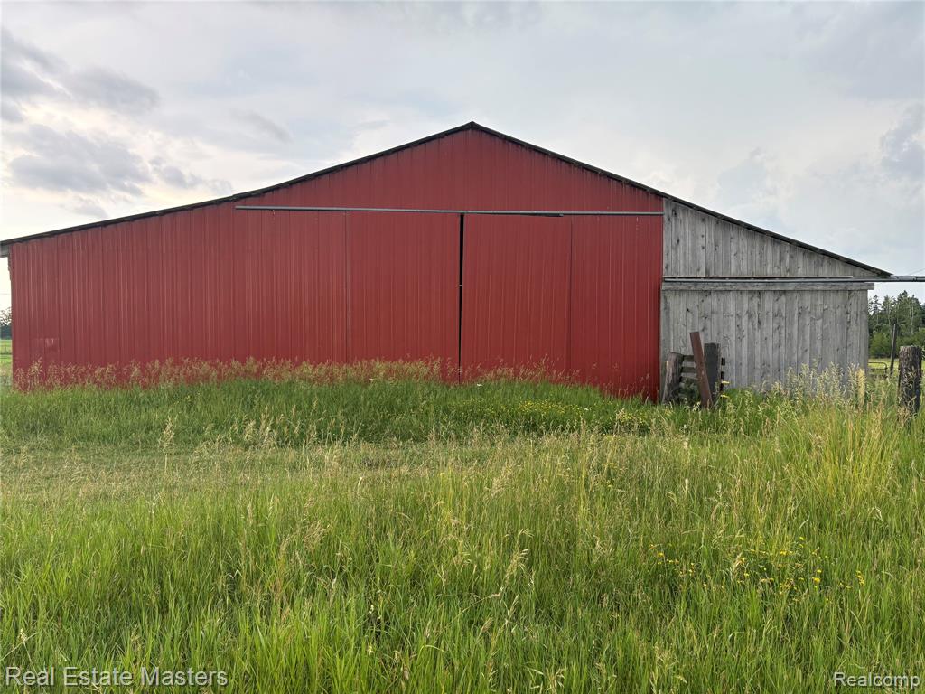Discover year-round adventure on this breathtaking peninsula property, near the stunning shoreline of Hubbard Lake. Set on nearly 90 picturesque acres, this unique parcel features a charming farmhouse, a spacious pole barn, a convenient tool shed, ponds, and paved road access—all just minutes from local shopping and amenities. The farmhouse boasts a durable metal roof and hardwood floors, combining classic charm with lasting quality.  Whether you're seeking a serene retreat or a recreational paradise, this property offers endless potential. Come experience your own slice of paradise!