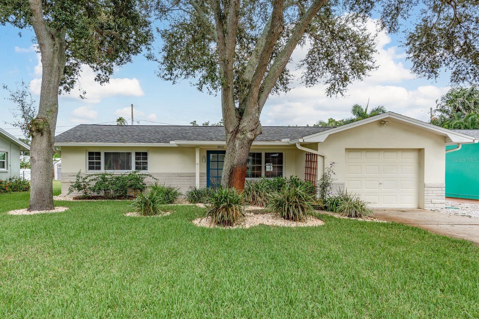 One or more photo(s) has been virtually staged. Welcome to 2013 Princeton Ave! This quaint and beautifully renovated Dunedin home features 2 bedrooms, 2 full bathrooms, and a 1-car garage. Enjoy this coastal community with NO HOA FEES, FLOOD ZONE X-500, GOLF CART ACCESSIBILITY and minutes away from the PINELLAS TRAIL, INTRACOASTAL WATERWAY and DOWNTOWN DUNEDIN!!! Thoughtfully updated in 2022, this home offers a modern feel with new luxury vinyl plank flooring, a beautifully updated kitchen with newer stainless steel appliances and granite counters, two renovated bathrooms, upgraded interior doors & trim, crown molding, lighting, and refreshed electrical outlets throughout plus an updated HVAC system!!! In 2023, a new roof with hurricane brackets was installed for added peace of mind. Water heater was replaced in 2018. Washer & dryer located in the pristine garage. The oversized fenced backyard includes a spacious stone-patio. Perfect for entertaining! There is also a storage shed and a well-fed irrigation system. Voted one of the best small towns in the south by Southern Living Magazine in 2023, the historic City of Dunedin has so much to offer. From white sandy beaches at the nearby award-winning Honeymoon-Island State Park to the bustling main street of downtown where culture and art flourish, Dunedin has endless festivities, amenities and things to do. The famous Pinellas Trail, the Fine Arts Center, Dunedin Community Center, golf course down the street, restaurants, craft breweries, and boutique shops are just a few of the things that make Dunedin so special. Take a stroll down the street to Highlander Park, a multi-use recreation area featuring a community center, Highlander Pool, spray-ground, 3-playgrounds, picnic pavilions, tennis & pickleball courts, basketball courts, sand volleyball court, and a baseball/softball little league field. There is also the beautiful Hammock Park offering 90-acre natural sanctuary with walking trails, boardwalks, playground, disc golf course and picnic area. All of this and more is accessible by legal golf carts. Don’t miss out on this amazing opportunity to own a piece of paradise in this rapidly growing and popular Florida town.