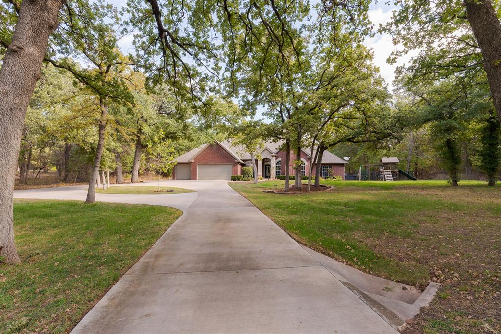 Situated on 2.650 beautifully treed acres within Edmond Public Schools. Privacy without compromise, convenient access to shopping, dining, medical services, and more along the thriving Covell and Sooner Rd. corridor. A winding driveway creates an inviting approach to this two-story home with a versatile floor plan and views that never end. The grounds are the highlight of the home with a covered patio off the main living room, outdoor fireplace, natural stone and steps leading to an in-ground swimming pool and guest house. The guest house is 352 sq. ft. and features a kitchen, full bath and large living/bedroom area. Every season brings another reason to enjoy this exceptional property. The main house includes approximately 3,626 sq. ft. of living space with 5 bedrooms, 3 full baths and 1 half bath, 2 dining areas, 2 living areas, dedicated study, and 3-car garage. The entry is flanked by a handsome wood-paneled study with fireplace and an open formal dining room. The main living area features a fireplace and expansive windows that capture beautiful views. The kitchen offers a ton of storage, gas range and counter space with an adjoining breakfast area. A split-bedroom arrangement provides exceptional flexibility, with the primary suite positioned separately from two secondary bedrooms, a flexible second living or recreation room with wood-and-glass doors, a full bathroom, conveniently located utility room and a half bath. The primary suite features direct access to the morning porch with a freestanding hot tub, en-suite bathroom, and impressively sized walk-in closet. Upstairs, two additional bedrooms with recently replaced carpeting share a Jack-and-Jill bathroom. Generous closet space throughout, a combination of wood floors, tile, and carpet, and well-planned layout add to the home's everyday comfort and functionality. Other highlights are a storage building, newer HVAC in guest house, Class 4 roof, newer flooring, fence around pool area, and many more features.