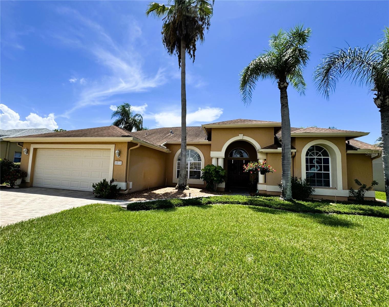 Welcome to the Estates of Beacon Woods, where Florida living meets privacy, comfort, and a beautiful natural backdrop. This inviting 3-bedroom, 2-bath pool home with a 2-car garage offers a thoughtfully designed split-bedroom floor plan, soaring ceilings, and an open, airy feel from the moment you step inside.Beautiful tile flooring flows through the main living areas, while expansive sliding glass doors draw your eye toward the screened lanai, sparkling pool, and peaceful conservation beyond. With no rear neighbors and lush greenery creating a picturesque backdrop, the outdoor living space feels like a private retreat—whether enjoying a quiet morning by the pool or entertaining beneath the spacious covered lanai.The kitchen connects easily with the surrounding living spaces, keeping the heart of the home open and welcoming. Privately positioned away from the secondary bedrooms, the primary suite offers a relaxing escape with an en suite bath featuring a separate walk-in shower, soaking tub, and private water closet.Outside, beautiful landscaping enhances the home's curb appeal and complements its serene setting. The combination of a pool, generous outdoor living space, conservation views, high ceilings, and a desirable split-bedroom design creates the Florida lifestyle so many are searching for.Located in the established Estates of Beacon Woods community in Hudson, this home offers a wonderful balance of residential tranquility and convenient access to shopping, dining, recreation, and Florida's Gulf Coast.Come discover a home where the view is green, the pool is inviting, and your backyard neighbor is nature.