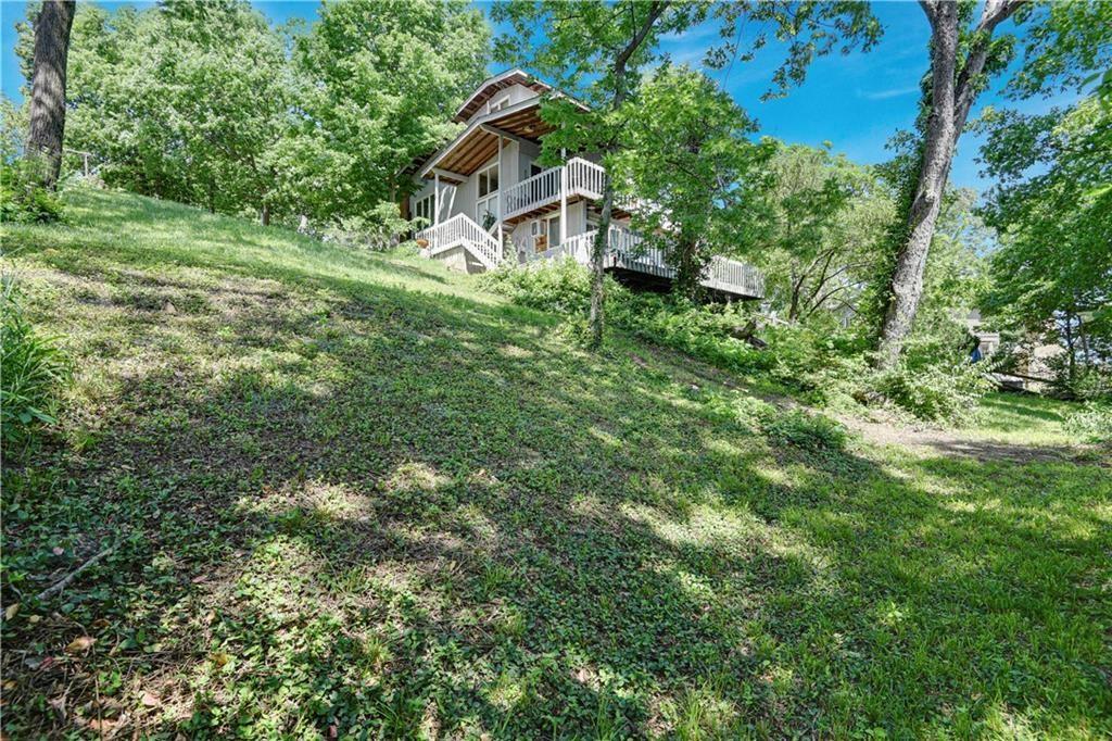 Looking to build at Lotawana?  Check out this awesome deal at Lake Lotawana! This sale includes 2- 1st tier parcels! Lots 14 and 15 L Street, Lake Lotawana, MO. This property offers you the rare opportunity to become the owner of
100+ feet of prime Lake Lotawana waterfront with 3 SINGLE WELL COVERED DOCKS.  Yes, 3 separate docks are included and all the space if you want to change the current setup.  This package includes a 3 bed, 2 bath residence on lot 14 and the adjacent vacant lot at 15.  Deep deep water off the end of the dock and sooo much room for all your lake toys! Act now to plan your new dream home at Lake Lotawana!