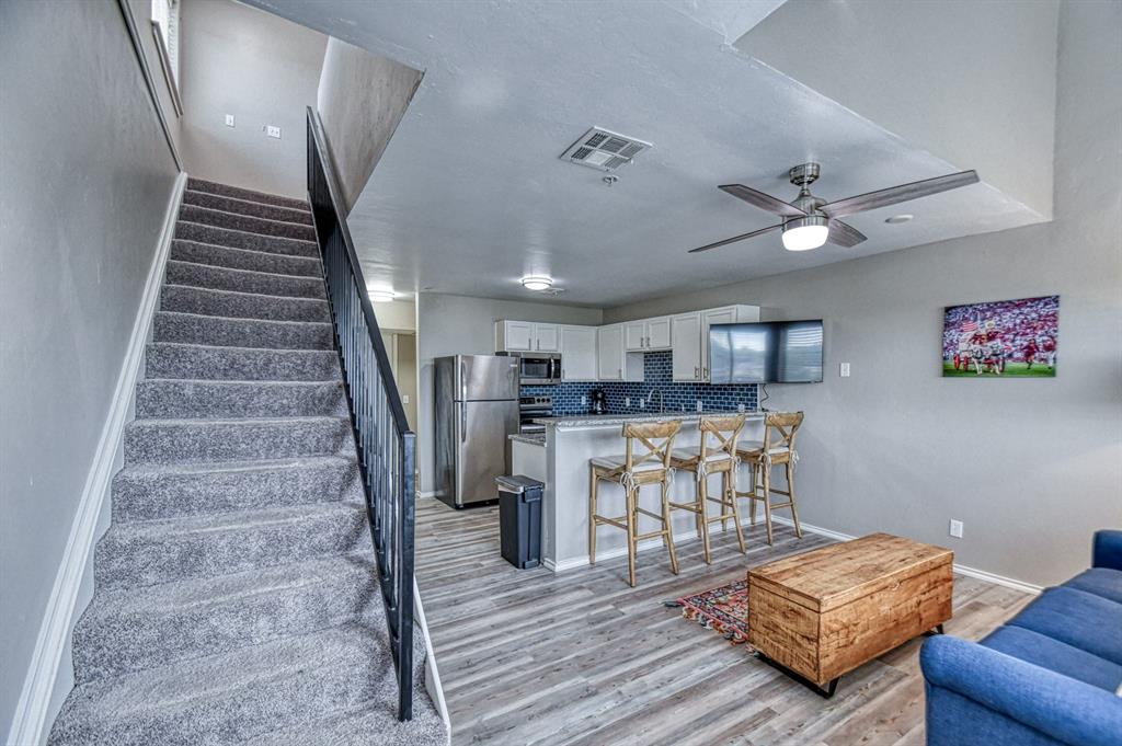 A modern and well-laid-out condo located just one mile from The University of Oklahoma! This contemporary upper unit features an open layout with high ceilings and an abundance of natural light. The neutral color scheme further enhances the bright, spacious feel of the living area.  The unit is move-in ready and comes fully equipped with all kitchen appliances including a refrigerator and washer and dryer.  The half bathroom downstairs is convenient and perfect for guests and entertaining.  Two spacious balconies, accessible from the living room and the upstairs bedroom, offer an intimate outdoor space.  The lofted upstairs bedroom is bright and spacious, featuring a large walk in closet and a modern ensuite bathroom.  This unit has everything you need in the perfect central location! Call your favorite real estate professional for a private showing today!