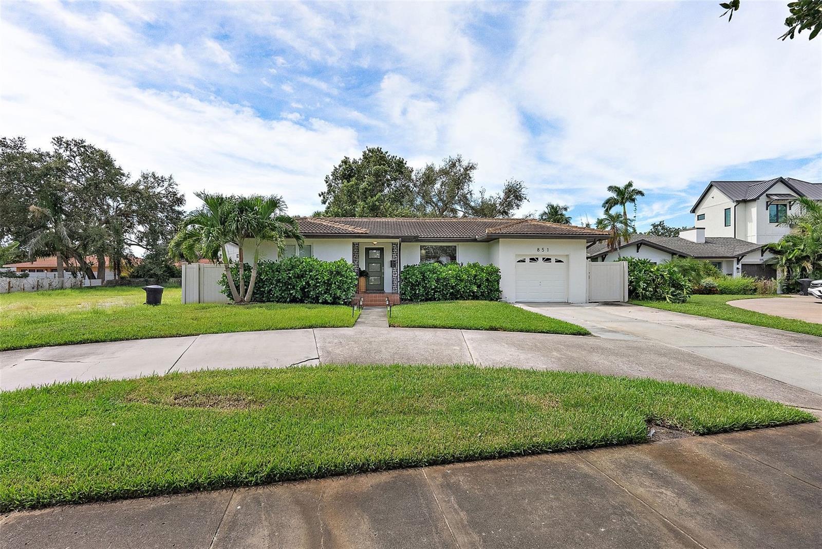 This is the home you’ve been waiting for!
Welcome to this beautifully remodeled 3-bedroom, 2-bath Spanish-style home tucked away in the heart of Snell Isle, one of St. Petersburg’s most coveted neighborhoods.

From the moment you walk in, you’re greeted by a bright and open living, dining, and kitchen space that feels both welcoming and elegant. Beautiful luxury vinyl wood flooring add warmth and character, perfectly complementing the stunning kitchen with its quartz countertops and large island — the perfect spot for entertaining friends or enjoying family time.

Just off the main living area, you’ll find a spacious family room centered around a cozy wood-burning fireplace, creating the perfect spot to relax and unwind.

The split floor plan gives everyone their own space, with a spacious primary suite featuring an extra-large walk-in closet that’s sure to impress.

Step outside and you’ll find an oversized lot with endless possibilities — plenty of room to add a pool, build a cabana house, or create your dream backyard retreat. The sky’s truly the limit!