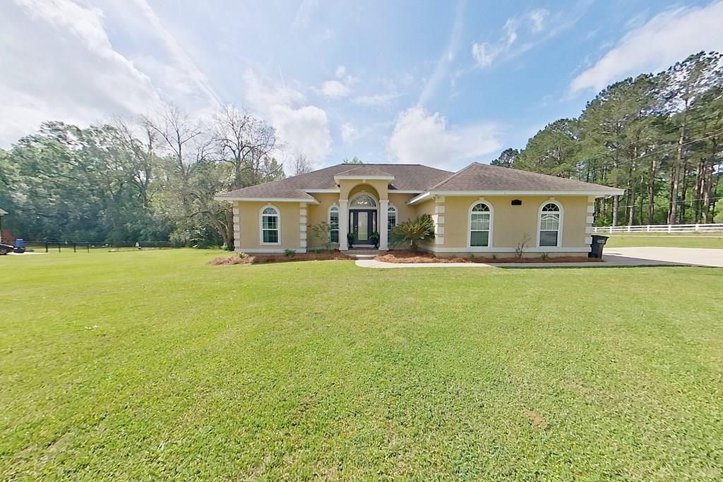 This charming home features an inviting open and airy split floorplan that effortlessly combines comfort and style! As you step into the grand foyer you are greeted with a warm and inviting family room with high ceilings and gas log fireplace. It opens onto a back screened porch which then opens up onto a recently added expansive covered back deck! The outdoor space is truly an oasis complete with decorative lighting, a fenced back yard, and fire pit! The oversized master bedroom is truly a retreat, complete with a luxurious tiled shower/soaking tub, double vanities, and walk-in closet. The spare bedrooms have ample space and roomy closets that will make organizing and storing a breeze. The heart of the home lies in the welcoming living and kitchen spaces designed for joyful gatherings with friends and family!  You'll also appreciate the practical features like a spacious mud/laundry room equipped with a handy folding table, hanging rack, and storage closet as well as a large double car garage and attic providing plenty of room for all your projects and toys!  This fantastic home is a true gem at a great price-combining elegance, functionality, and a warm, welcoming vibe.  Don't miss the chance to make it your very own!  Virtual tour link: https://unbranded.youriguide.com/102_mimosa_ln_cairo_ga/