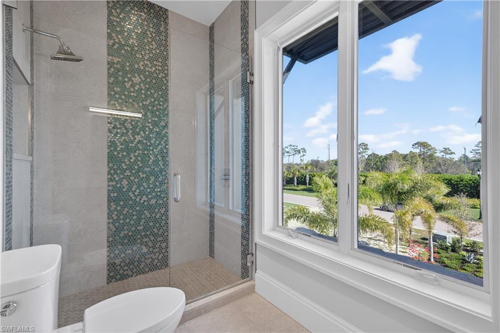 Full bath with toilet and a stall shower