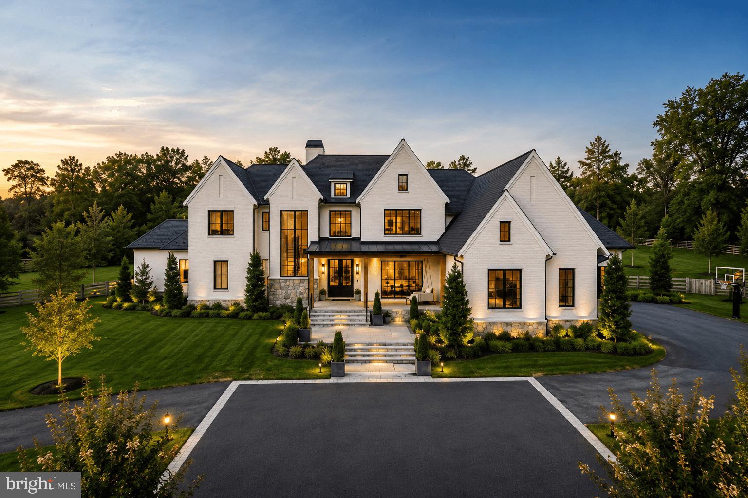This European Modern custom residence has been meticulously conceived for both refined daily living and gracious entertaining. The resort-inspired grounds, designed by Charles Owen of Fine Landscapes, provide an exceptional outdoor setting featuring an expansive swimming pool, a covered outdoor kitchen with al fresco dining, an inviting outdoor living room with fireplace, a putting green, game area, and a thoughtfully placed fire pit for evenings under the stars.Inside, the home reflects uncompromising attention to detail throughout. The main-level owner’s retreat is a private sanctuary, highlighted by a vaulted ceiling and fireplace, and enjoys tranquil views overlooking the pool and gardens. Custom his-and-hers closets and a dedicated private office complete this serene suite. The elegant Dining Room opens to a charming covered porch adorned with a classic swing and the Family Room exudes warmth and sophistication, featuring a beamed ceiling, marble fireplace, bespoke built-in bookcases, and an intimate bar area, perfect for both casual gatherings and formal entertaining. The Lobkovitch custom kitchen is beautifully appointed with top-of-the-line everything and includes discreet access to a prep kitchen and a mudroom entry with tailored built-ins to the 4-car garage. The sun-filled Breakfast Area opens effortlessly to the screened porch and outdoor living spaces beyond.The upper level is designed with family comfort in mind, offering five en suite bedrooms, several with charming lofts, along with an upstairs studio and game room. The lower level provides a luxurious retreat for leisure and entertaining, featuring a recreation room anchored by a dramatic glass-enclosed wine display, a wet bar, a massage room, a dedicated music room and bedroom suite. Altogether, this extraordinary home presents a rare balance of elegance, comfort, and versatility.