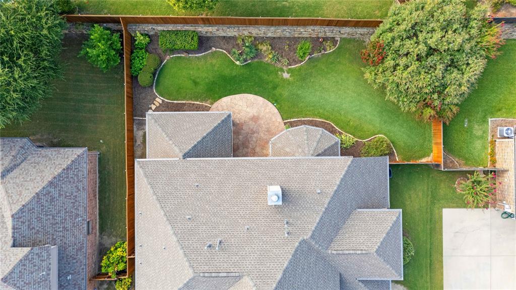 MULTIPLE OFFERS RECEIVED-Welcome to Woodhaven- Home faces South South East– Luxury Living with Golf Course Views! Exceptional home nestled in the heart of Stonebridge Ranch, one of North Dallas’s most sought-after master-planned communities. The chef’s kitchen is the heart of the home, featuring GE stainless steel appliances, granite countertops, custom oak cabinetry, an oversized island with seating and s separate butler’s pantry with a wine refrigerator. The open-concept design flows effortlessly into the main living area, complete with a wall of windows and a gas fireplace with ceramic logs. The primary suite is a true retreat, offering a sitting area with bay windows, a spa-inspired bath with a jetted garden tub, dual sinks, and a massive walk-in closet with off-season clothes rack. The guest suite has its own private exterior entry and en-suite bath, ideal for multi-generational living or visitors. A dedicated home office with french doors, fiber optic internet, and structured cabling ensures productivity and privacy. Upstairs, enjoy a fully equipped media room with projector and screen, a spacious game room with built-in bench seating, and two large floored attic spaces with heavy-duty shelving. You will also find a jack & jill bathroom upstairs conveniently located en-suite to both bedrooms.  An additional guest bedroom with a ensuite bathroom is located on the second floor. Other Upgrades include freshly painted interiors (2025), new carpet (2025), waterproof luxury vinyl plank flooring, and smart switches throughout. The home also features a 3-car split garage with workbench and storage, an extended stamped concrete patio, and a professionally refreshed landscape with new sod and stained wood accents (2025). Mechanical updates include a new roof and gutters (2022), leaf guards (2023), HVAC systems (2023–2024), and dual water heaters (2019). A smart sprinkler system adds to the home’s efficiency.