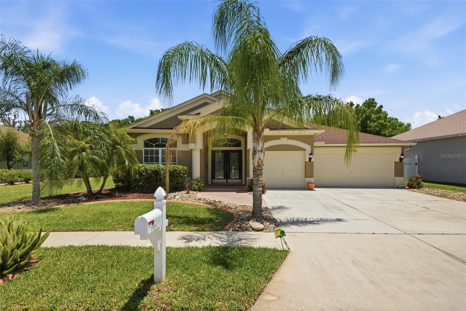 Welcome to the highly desirable Lexington Oaks Golf Club community. Perfectly positioned along the 8th hole, this beautifully maintained home offers tranquil GOLF COURSE VIEWS from the private screened lanai overlooking the tee box — the ideal setting to relax and enjoy Florida living. From the moment you arrive, you’ll appreciate the home’s exceptional curb appeal, highlighted by upgraded pavers, gutters, and mature palm landscaping that enhances the property’s inviting exterior. Elegant French front doors create a warm and impressive entrance into the spacious interior. Inside, the home features a desirable split floor plan that provides both privacy and functionality. Formal living and dining room areas offer the perfect spaces for entertaining guests or hosting special occasions, while the open-concept main living areas create a comfortable everyday flow. The kitchen is thoughtfully designed with plenty of cabinet space, granite countertops, stainless steel appliances, a breakfast bar, cooking island, and complemented by premium water systems, including a Flow-Tech system and reverse osmosis filtration. An indoor laundry room adds everyday convenience and practicality. The functional layout also features a desirable 3-car garage, offering ample space for storage and convenience. Recent major updates provide added peace of mind, including the roof and HVAC system, both replaced in 2022. Blink security cameras will also convey with the home. This exceptional golf course residence combines comfort, quality upgrades, and picturesque surroundings in one of Wesley Chapel’s established golf communities. Lexington Oaks is a deed-restricted golf community with many amenities including a championship 18-hole golf course, fitness center, heated pool, soccer, tennis, basketball & volleyball courts, playground, splash pad, clubhouse, and Omari's Bar & grill. Lexington Oaks is conveniently located near daycares, schools, hospitals, restaurants and several major shopping districts.