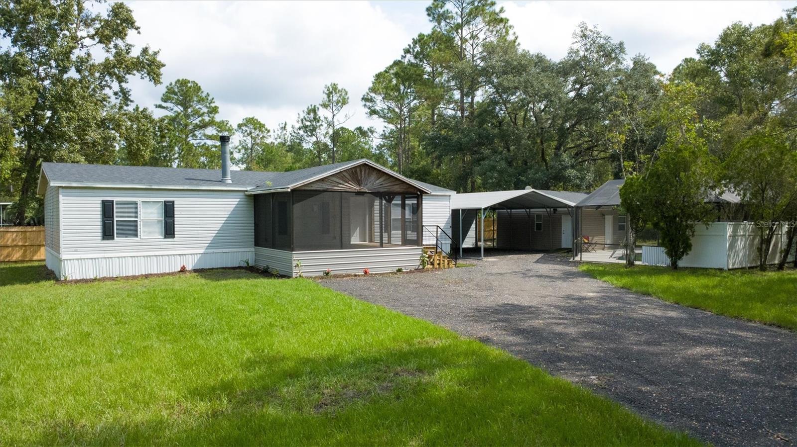 Move-In Ready 3BR/2BA Home with Pool, Pool House & Carport,  Welcome to your private Florida retreat! This spacious 3-bedroom, 2-bath double-wide manufactured home offers over 1,500 sq. ft. of comfortable living space with Luxury Vinyl Plank (LVP) flooring throughout, ceiling fans in every room, and a smart layout for everyday living and entertaining. The modern kitchen includes a refrigerator, stove, microwave, and dishwasher, all ready for your move-in.
Step outside to your sparkling pool and relax in the 20x20 pool house, perfect for guests, a home office, or a personal gym. The 25x24 carport provides ample covered parking or workspace, and the partially fenced yard adds privacy and room for pets or play. Additional highlights include a brand-new roof and brand-new water heater for peace of mind.
Located in the serene Daytona North subdivision, this home combines comfort, functionality, and Florida outdoor living—all at a great value!