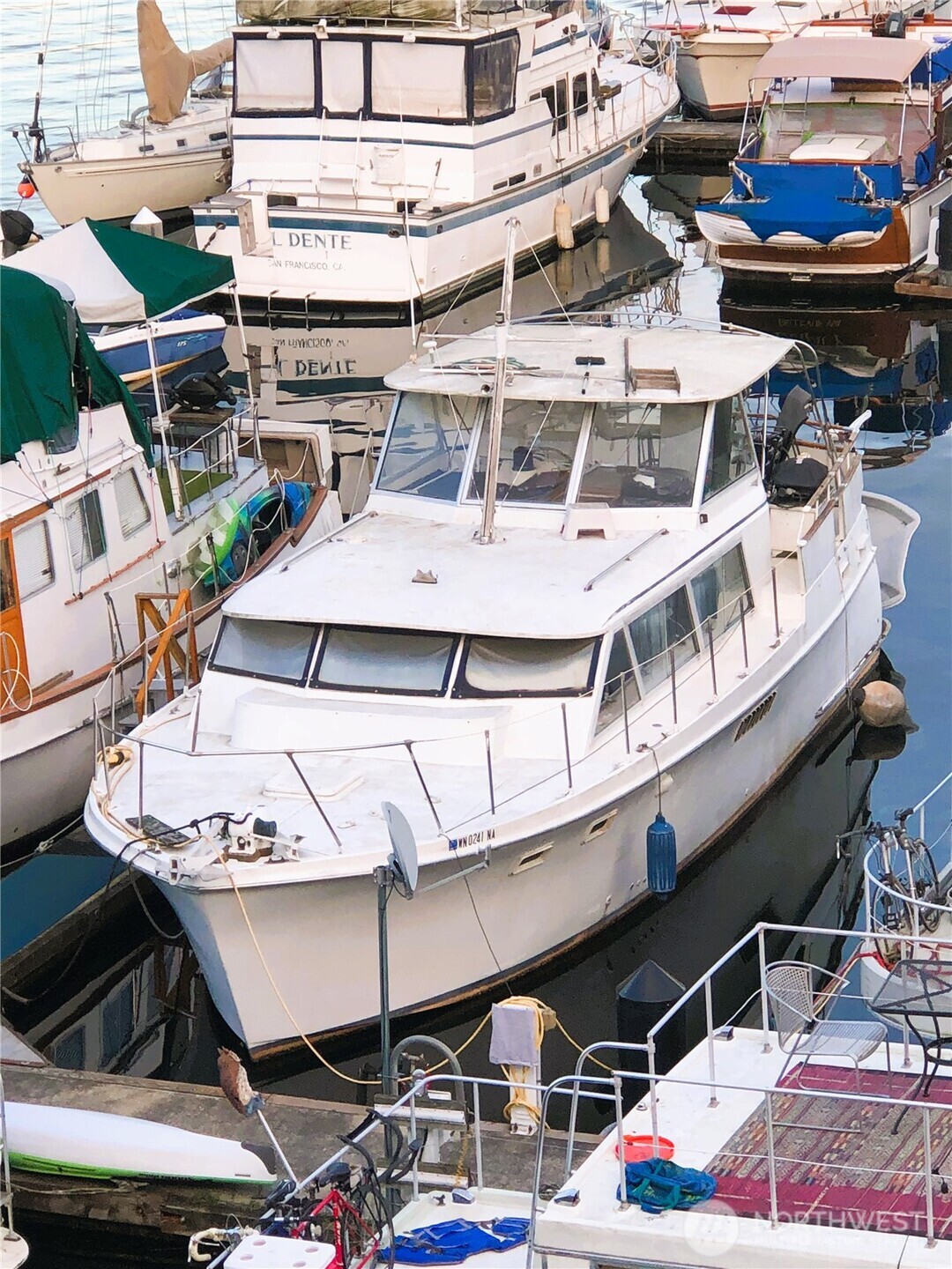 Make this 41' Hattaras your home or your income-producing property! Marina allows Airbnb of 30 days or longer and it's easy to keep this one occupied in its central Lake Union location. Fully furnished, includes all appliances, kitchenware, bedding, TV, etc. to make it a turn-key Airbnb or ready for your easy move in.  Large bright living area, Queen bed plus seating in the aft cabin w/ 3/4 bath, plus twin bed & built-in desk in the forepeak. City-registered FOWR plaque of 41 x 14 gives you possible replacement options in the future to build a houseboat with the same footprint. Liveaboard slip is located conveniently on the Burke Gilman trail in the center of Westlake that provides great views of Gasworks Park, Lake Union & Downtown.