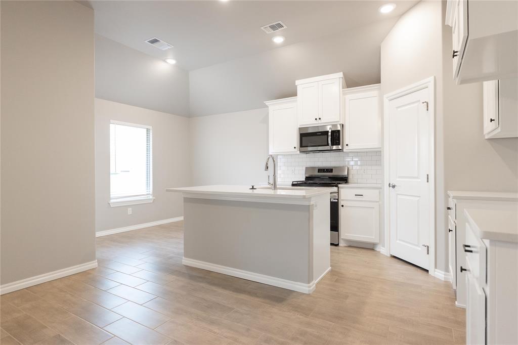 FENCING AND BLINDS INCLUDED! This Norma floor plan includes 1,425 Sqft of total living space, which includes 1,300 Sqft of indoor living and 125 Sqft of outdoor living space. There is also a 385 Sq Ft, two car garage with a storm shelter installed. This amazing and affordable home offers 3 bedrooms, 2 full bathrooms, 2 covered patios, and a utility room! The great room presents a 10-ft ceiling with large windows, wood-look tile, a ceiling fan, hand-textured walls, and Cat6 wiring. The spacious kitchen includes beautiful countertops, stainless-steel appliances, custom-built cabinets, wood-look tile, a large corner pantry, and a center island that holds a dishwasher and a roomy sink. The primary suite supports a high ceiling, lovely windows, a ceiling fan, Cat6 wiring, and our cozy carpet finish. The primary bath is attached and holds a dual sink vanity with an elegant countertop selection, satin nickel delta features, an elongated water saving toilet, and a spacious walk-in closet. Outdoor living includes fully sodded yards, a smart home irrigation system, and 30-yr weather wood shingles. Other amenities include a tankless water heater, R-15 insulation, a fresh air intake system, and so much MORE!