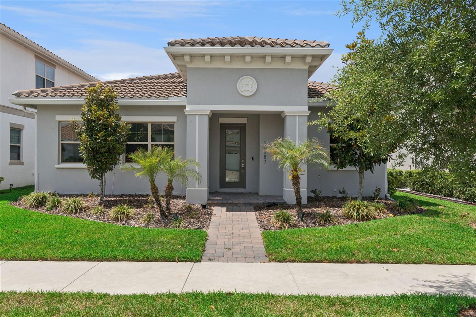 Welcome to 10387 MacDuff Drive—an elegant, single-story Mediterranean-style residence that blends timeless charm with modern luxury in one of Orlando’s most sought-after golf communities Eagle Creek.At the heart of the home, the gourmet kitchen is designed to impress and inspire. Featuring gleaming quartz countertops, stainless steel appliances, a built-in oven, and custom cabinetry that extends all the way to the ceiling, this space is both functional and stunning. Just beyond, a thoughtfully designed scullery adds convenience and sophistication with its own prep sink and granite countertops—perfect for entertaining or keeping the main kitchen pristine.The spacious living room offers a warm yet refined atmosphere, enhanced by custom lighting and expansive pocket sliding doors. These open seamlessly to a screened-in porch, creating an effortless flow between indoor and outdoor living—ideal for relaxing evenings or hosting gatherings year-round.The large master suite is a private sanctuary, offering both comfort and luxury. Enjoy an oversized walk-in shower, dual vanities, and an oversized walk-in closet designed for optimal organization. Every detail has been carefully curated to create a spa-like experience at home.Two additional bedrooms provide ample space for family or guests, complemented by a well-appointed second bathroom that maintains the home’s elevated style and finishes.An inside laundry room adds everyday convenience, while the drop-zone mudroom just off the two-car garage is as practical as it is stylish—complete with built-in cabinetry and benches to keep everything organized and within reach.Situated in the beautiful Eagle Creek community, this home benefits from meticulously maintained surroundings and resort-style amenities including a championship golf course, tennis courts, a fitness center, clubhouse, community pool, and playgrounds. Just minutes from premier shopping, dining, and everything Lake Nona has to offer, this location delivers both tranquility and accessibility.A rare blend of comfort, design, and location, this home offers an exceptional opportunity to experience elevated Florida living at its finest.