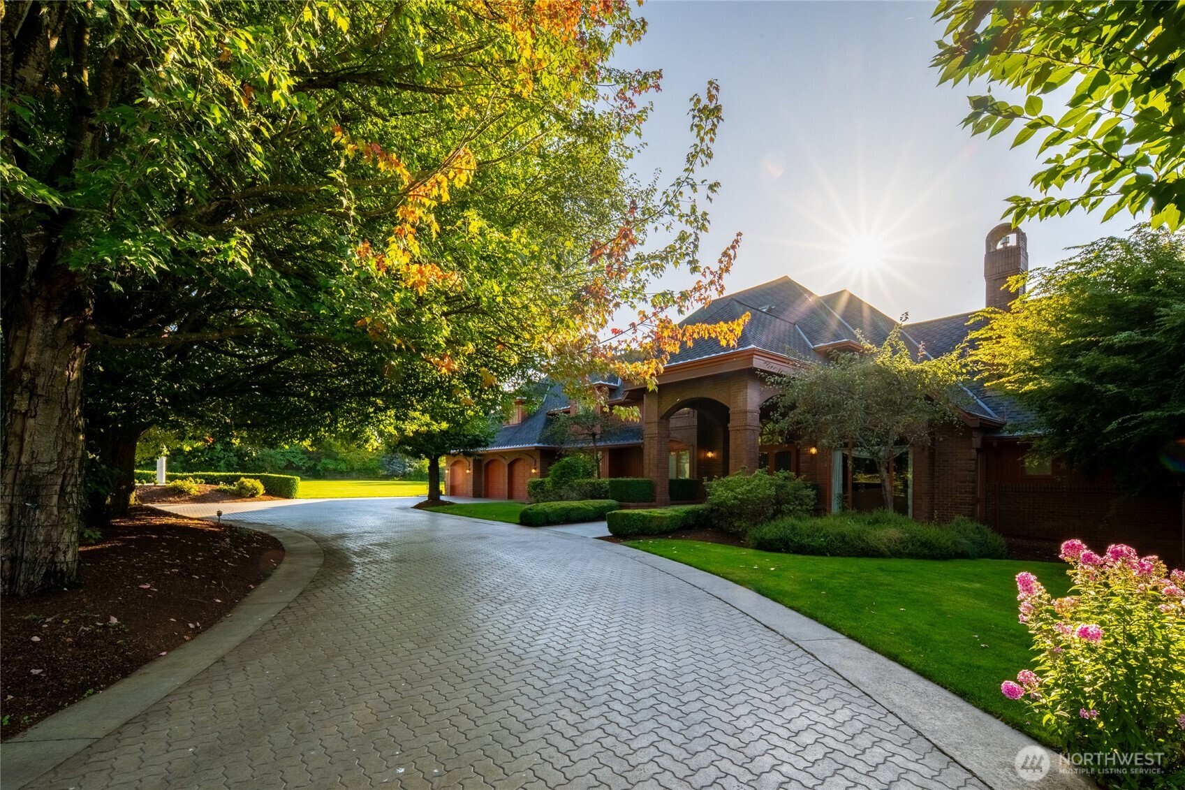 Welcome to your private Pacific Northwest retreat-nearly 5 acres at the end of a quiet dead-end road, where privacy and craftsmanship unite. A gated entry opens to an expansive paver driveway with circular approach, framed by mature trees and landscaping, leading to a covered arched portico. Inside, a dramatic 24-foot two-story foyer and sweeping curved staircase make a stunning first impression. Main level offers a formal living room with arched window and gas fireplace, formal dining provides the perfect setting for memorable gatherings, and a well-appointed kitchen with stainless appliances, granite counters, walk-in pantry, built-in desk, bar seating, and breakfast nook flowing into the great room with French doors and wood-burning fireplace. The large primary suite on the main offers a tray ceiling, French doors to the covered deck, and a spacious walk-in closet. Also downstairs are a dedicated den/office and a dreamy laundry room. Upstairs are four bedrooms with Jack-and-Jill baths, three featuring walk-in closets and charming window seating. An expansive rec room serves as the ultimate hangout destination, and a third-level flex space with storage adds versatility. Outdoor living shines with a covered timber-framed deck, vaulted wood ceiling, irrigated and fenced yard. A heated 3-car garage with half bath, basement garage, 4-bay shop with 44-foot RV bay and 3/4 bath, and a 1,000+ sq ft ADU with kitchen, bath, and covered balcony complete this exceptional gated estate.