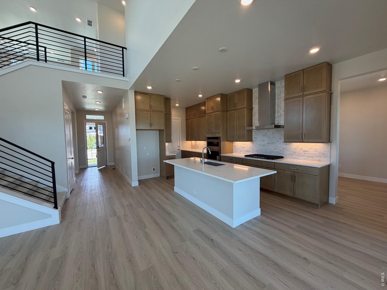 This completed Trumark Homes Plan 3 at Kitchel Lake features an oversized 4-car garage with a farmhouse elevation style. This expansive two-story plan offers 3,733 Sq. Ft. of finished living space, including the finished basement. Beyond the entry hall is the gourmet kitchen featuring 42" deluxe cabinetry with soft close features, quartz counter tops with tile backsplash, stainless steel Kitchen Aid appliance package with a 5-burner gas cooktop, a convection oven, a built-in microwave, and a dishwasher. Great pantry for even more storage! The kitchen conveniently connects to the pocket office and the covered outdoor room - great way to expand your main floor living space. Convenient main floor bedroom is a great place for a secondary office or guests. Upstairs, you'll find a welcoming bonus room for reading, tv watching, gaming or hobbies. The two secondary upstairs bedrooms are connected by a jack-n-jill bathroom with dual sinks. Down the hall, the primary suite offers a luxurious, spa-like bathroom with a walk-in shower, freestanding tub and an expansive walk-in closet. This home features the Diana Plus design finish package with extensive luxury vinyl plank flooring, luxurious carpet in bedrooms, contemporary bath fixtures, a tankless water heater, dual zoned heating, air conditioning, solar rough-in and much more! The basement is finished with bedroom, bathroom and recreational room. This home comes fully landscaped and fenced and backs to open space. What a great value - and even better - lender incentives are available on this special home!