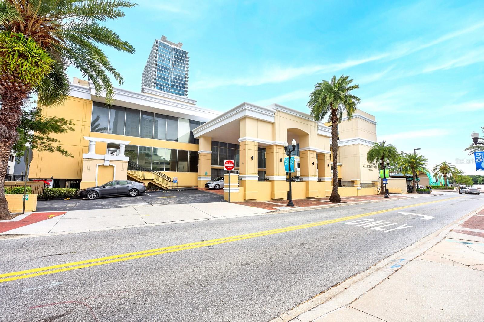 Seller may consider buyer concessions if made in an offer**Welcome to urban living at its finest in The Metropolitan at Lake Eola, where style, convenience, and an UNBEATABLE LOCATION come together in the heart of downtown. This WELL-MAINTAINED 2-bedroom, 2-bath second-floor condo is perfectly positioned just across the street from LAKE EOLA PARK, offering the ultimate walkable lifestyle. Step inside to a spacious and inviting Living Room, enhanced by LUXURY VINYL PLANK FLOORING that flows throughout the entire home. The layout transitions effortlessly into the Kitchen, featuring a BREAKFAST BAR, ample cabinetry and counter space, and a conveniently tucked-away stacked washer and dryer for everyday ease. The Kitchen overlooks a GENEROUS FLEX SPACE that can serve as a Family Room or Dining area, complete with an opening to a private patio—perfect for enjoying your morning coffee or unwinding in the evening. This UNIQUE FLOOR PLAN offers TWO PRIMARY SUITES, each with its own walk-in closet and private en suite bath, providing ideal comfort and privacy for residents and guests alike. Additional highlights include TWO DEEDED PARKING SPACES in the covered garage, a rare and valuable feature for downtown living. Residents of The Metropolitan enjoy an array of RESORT-STYLE AMENITIES, including a newly renovated pool, clubhouse, 24-hour fitness center, valet trash service, on-site maintenance, and secured access with video surveillance. Take advantage of the ROOFTOP VIEWS overlooking the Lake Eola Bandshell, where you can enjoy concerts, events, and fireworks right from your own building. With its PRIME LOCATION,  you’ll love being near Publix, the vibrant dining and nightlife of THORNTON PARK, the popular LAKE EOLA FARMERS MARKET, and WORLD-CLASS ENTERTAINMENT at the Dr. Phillips Center for the Performing Arts and Kia Center (formerly Amway Center). With EASY ACCESS to major roadways like Interstate 4 and State Road 408, commuting throughout Central Florida is effortless. Whether you’re looking for a full-time residence or a VIBRANT CITY RETREAT, this condo provides a perfect blend of comfort, style, and an unmatched downtown lifestyle. Opportunities like this don't come around often, so schedule your showing today!