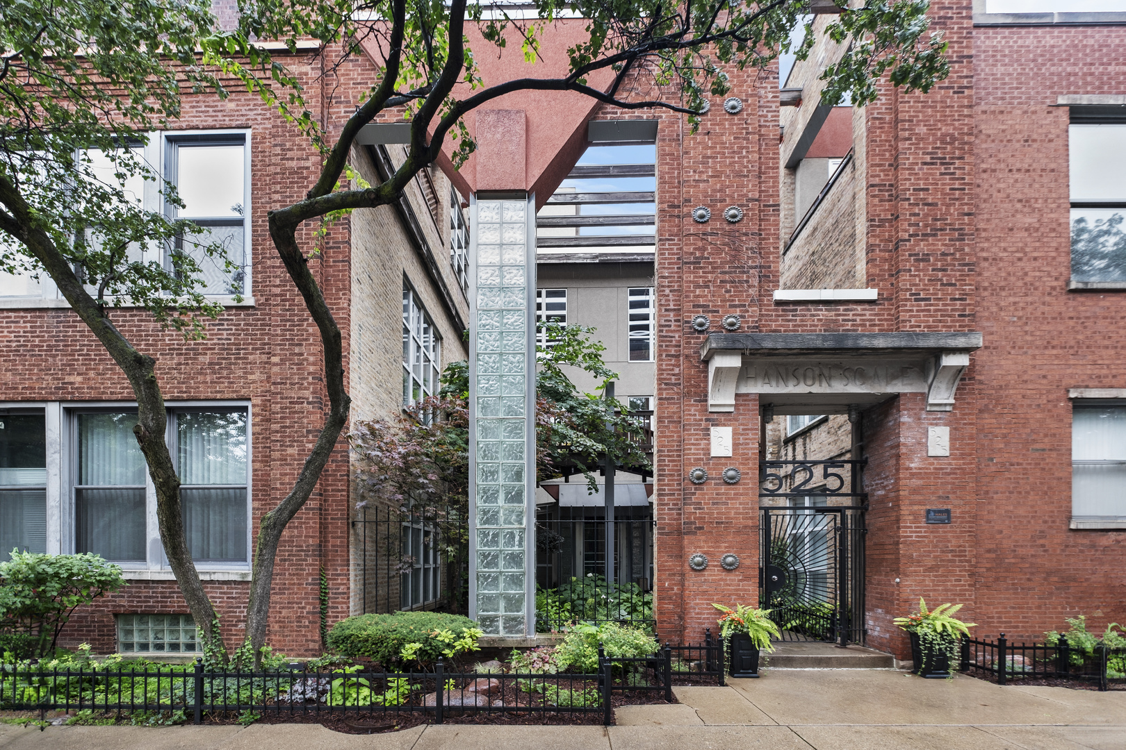 Welcome to this beautifully updated 2-bedroom, 1-bath loft tucked away on a quiet, tree-lined street in the heart of charming West Town. Located in the highly sought-after Ada Street Lofts, this home features soaring 14-foot timber ceilings, exposed brick walls, hardwood floors, and a cozy wood-burning fireplace-perfect for relaxing or entertaining.    The timeless kitchen offers granite countertops, rich cabinetry, and stainless steel appliances. Enjoy the comfort of in-unit laundry and abundant storage throughout, including a walk-in closet and oversized windows that flood the space with natural light.    Thoughtfully constructed with concrete flooring between levels for enhanced sound insulation, this well-maintained building also offers a shared rooftop deck with panoramic views of the city skyline. Gated parking is included, with easy access to the expressway, downtown, and public transportation.  New AC unit this year!