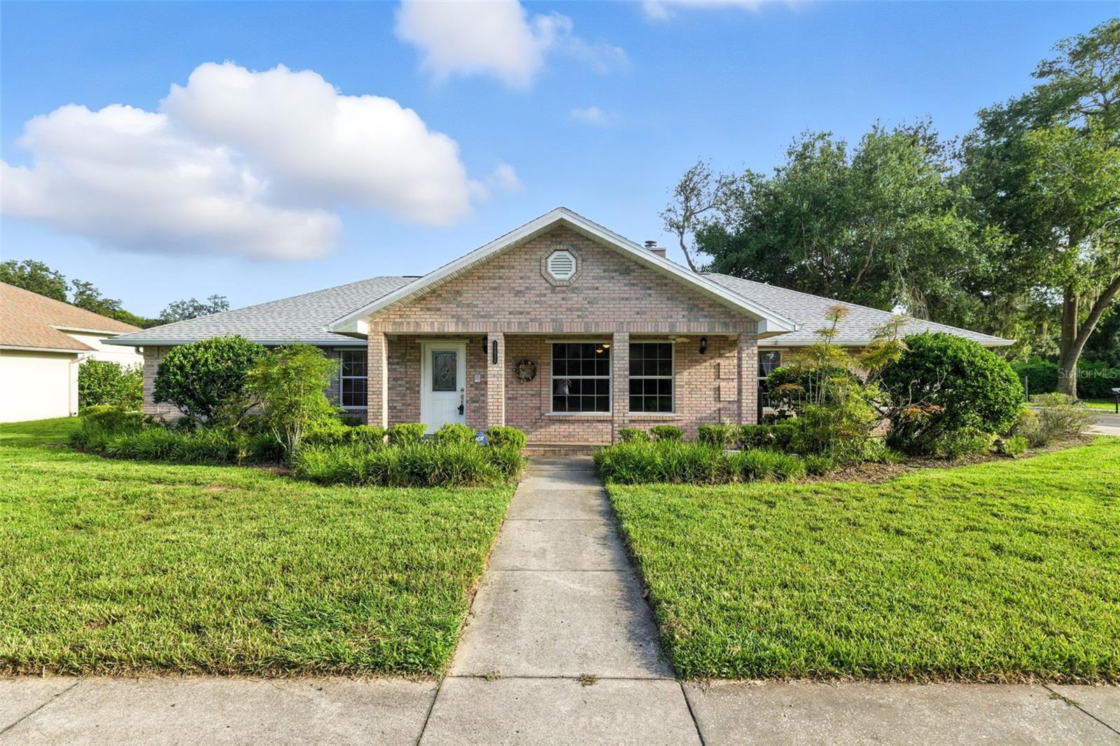 One or more photo(s) has been virtually staged. Charming Brick Home with Spacious Living in Zephyrhills! Come see this beautiful 1998 single-family brick home, perfectly situated on a corner lot in the heart of Zephyrhills. With 1,952 sq. ft. of living space, this home blends comfort, charm, and thoughtful updates you’re sure to love—including a brand-new roof (2025) and new carpet in 2 bedrooms! This home offers 3 bedrooms and 2 bathrooms, plus an oversized 2-car side-entry garage with attic storage and space for a workshop. Situated on a large corner lot, lush landscaping adds curb appeal, while the front sitting area creates a welcoming spot for morning coffee or evening sunsets. Inside, the huge living room features a cozy fireplace—perfect for family gatherings or quiet nights in. The spacious kitchen and dining area are ideal for cooking and entertaining, offering plenty of cabinets, drawers, and a large pantry. A bonus room just off the dining area provides flexible space for a home office, craft room, or playroom. The primary bedroom and additional bedrooms are generously sized and can easily accommodate larger furniture. The home also includes a central vacuum system and a convenient laundry closet with washer and dryer. Located less than a mile from local grocery stores and just minutes from Zephyrhills’ favorite diners, shops, and parks, this home provides a perfect balance of small-town living with everyday convenience. Don’t miss the chance to call this well-maintained, move-in-ready property your own. Schedule a tour today and see why this home is such a standout in Zephyrhills!
