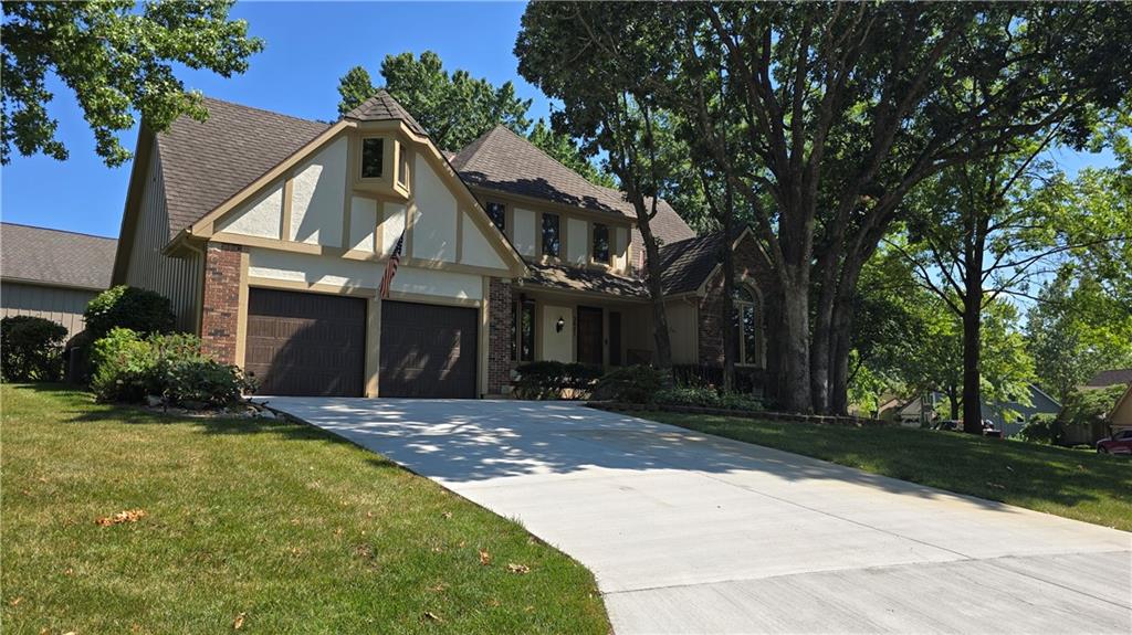 Truly serene view of Lakewood that must be seen from the oversized windows on the Main Level and Second Level!  The Main Level has everything you need!  Large enough for everyone with separate 1 car garage downstairs and oversized 2 car garage upstairs walking right into the kitchen with main level access, the formal dining room with large picture windows facing the lake side (west) for entertaining, or downstairs where a guest room with full bathroom, office, and 2 large multi-function rooms and private garage access converted to energy saving LED lighting.  Reliability & security provided by solar panels & Generac Whole Home Generator, but a warm fireplace in the large Great Room right off kitchen eat-in breakfast/gathering area is fully functional for those cozy MO nights! Right outside the dining area windows and open Great Room side door is the private added & maintained patio and hot tub area! The full kitchen, visible from the upper level, patio, & Great Room, is complete with lovely finished wood accents & trim throughout home.  The cooks will LOVE the BlueTooth GE double oven and Samsung fridge/freezer combo with drawers and a half bathroom next to the laundry room for quick trips!  Long-term perennials surround the front landscaping with shady trees facing toward the relaxing lake views & glimmers of sunlight coming off of Lakewood Lakes. Well insulated 3 bedrooms & full bathroom complete the private upstairs with lower level views of the atrium & Great Room.  Smart, Energy Efficient, Beautiful, Relaxing, & the forever site for your forever home as the private primary area has a jetted tub with skylight across from the double vanity with full wall mirror open to the full walk-in closet, linen closet, and full bathroom!  See the Lakewood Properties documents attached or available from their website.  Transferable Appliance warranties & a serviced lawn sprinkler system!