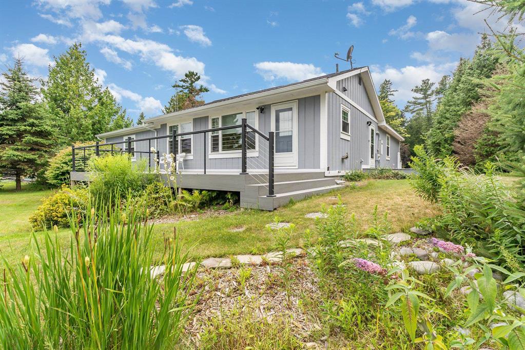 Escape to your own private Great Lakes retreat with this charming 3-bedroom, 3-bath cottage set on 2.75 wooded acres and boasting over 100 feet of pristine, walkable sandy shoreline on Lake Huron. Tucked away from the highway in a quiet, natural setting, this property offers the perfect balance of privacy and breathtaking water views. Enjoy endless days on the beach, where the soft sand meets crystal-clear water-free from the noise and crowds. Relax on the Trex deck overlooking the lake, take in the ever-changing colors of the horizon, and listen to the waves roll in. Inside, youll find a well-maintained home with the comfort of a whole-house Generac generator, a newer roof, and plenty of space to make memories with family and friends. The propertys generous acreage provides room to grow, roam, and explore, whether you envision adding guest accommodations, gardens, or recreational space. This rare opportunity to own a slice of Lake Huron paradise combines the best of waterfront living with a peaceful, intimate setting-making it an ideal getaway or year-round home. Recent inspection available along with property survey.