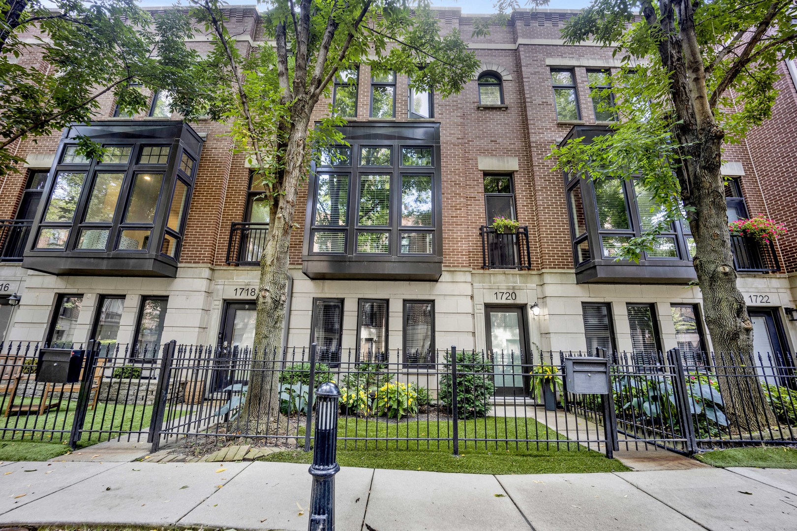 Move right into this impeccable gem at highly desirable Columbia Place in beautiful, tree-lined, Lakeview.  All brick and perfectly maintained, this 4 bedroom, 2.1 bath townhome checks off all the boxes.  The first floor features heated floors and a great bedroom/den with built in Murphy bed and loads of built-in storage and a smart half bath.  Main floor boasts luxury living with pristine hardwood flooring, a sleek open kitchen/living area with deluxe stainless appliances, white cabinetry and flooded with natural light from three large sliding doors that open to a lovely balcony. The excellent layout includes perfect flow into a generous open dining room and living room space with great light and distinctive fireplace with custom built-ins. Upstairs find three bedrooms and two full baths.  Primary suite includes huge walk-in closet and ensuite bath with double vanity and large custom tiled glass enclosed shower. In unit washer/dryer and stairway to a wonderful, private rooftop deck complete the floor.  Other great features include attached 2 car garage, lovely landscaped front yard enclosed by a wrought iron fence and courtyard. Great location! Burley School District.  Steps to parks, shopping and restaurants and all conveniences nearby, including Jewel, Whole Foods, Trader Joe's, Mariano's, Wrigley Field, and the Lake.