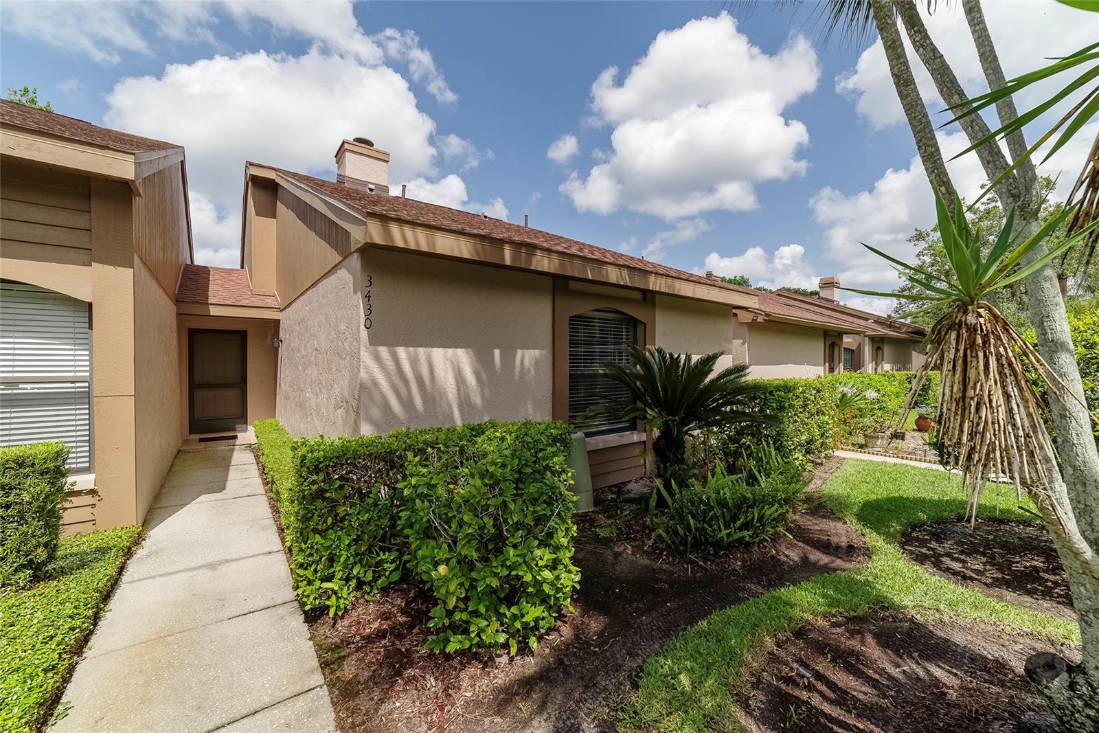 Virtually staged. Water View! You will not want to miss this updated 2-bed, 2-bath Villa in desirable Brookhaven. This GATED Community in Ridgemoor offers maintenance free living in the heart of Palm Harbor! Updated wood-like tile throughout. Great room features vaulted ceilings, a cozy fireplace, and scenic water views. Beautifully updated kitchen with eat-in counter, stainless steel appliances, granite countertops, decorative backsplash, under cabinet lighting, and dark wood cabinets. Enjoy beautiful water view sunsets every night from the covered patio. Primary bedroom features an ensuite bathroom and walk-in closet. Enjoy the convenience of an inside washer and dryer and updated bathrooms. A/C installed in 2023. Pet friendly community & super location close to John Chestnut Park with a variety of wildlife and Lake Tarpon for boating & dog park, N Pinellas Trail and YMCA, shopping, restaurants, and golf courses nearby. Short drive to the beach, Tampa International Airport & PIE Airport. Easy commute to Tampa and St. Pete. Flood insurance not required.