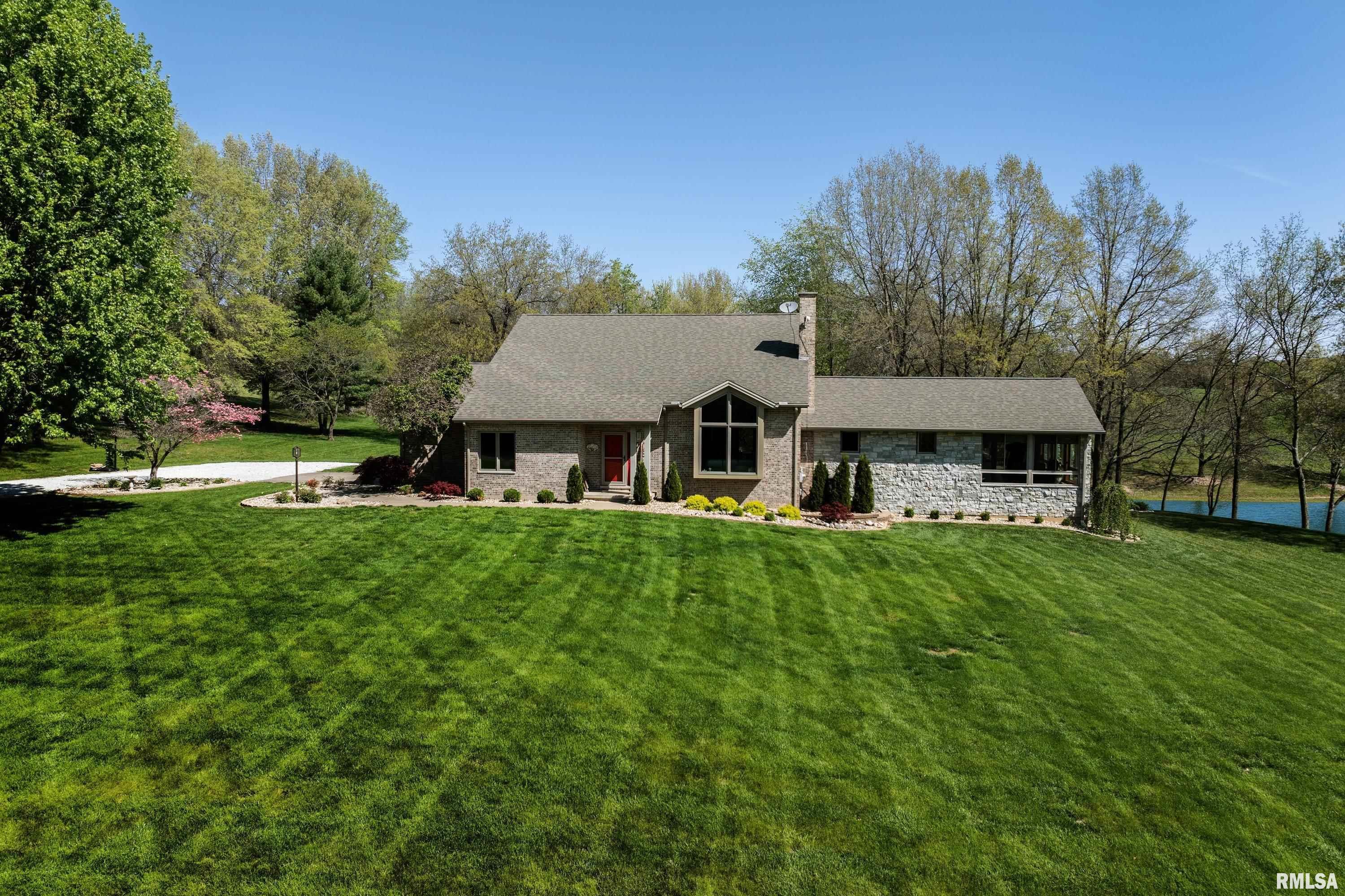 Stunning home in an unbeatable location! Situated on 5 acres just outside of town, this property offers a beautiful pond, partially wooded acreage, and private trails. Originally built by W.C. Holzgrafe, with a primary suite addition by Tom Stupavsky Construction, pride of ownership by the original owner is evident throughout this impeccably maintained home. The main floor primary suite addition features a spacious layout and a 4-season room overlooking the pond. Roof and addition completed in 2022, along with composite decking for low-maintenance outdoor living. Two HVAC systems, with the main system replaced in 2026. Enjoy peaceful views, privacy, and space—this one is a rare find!