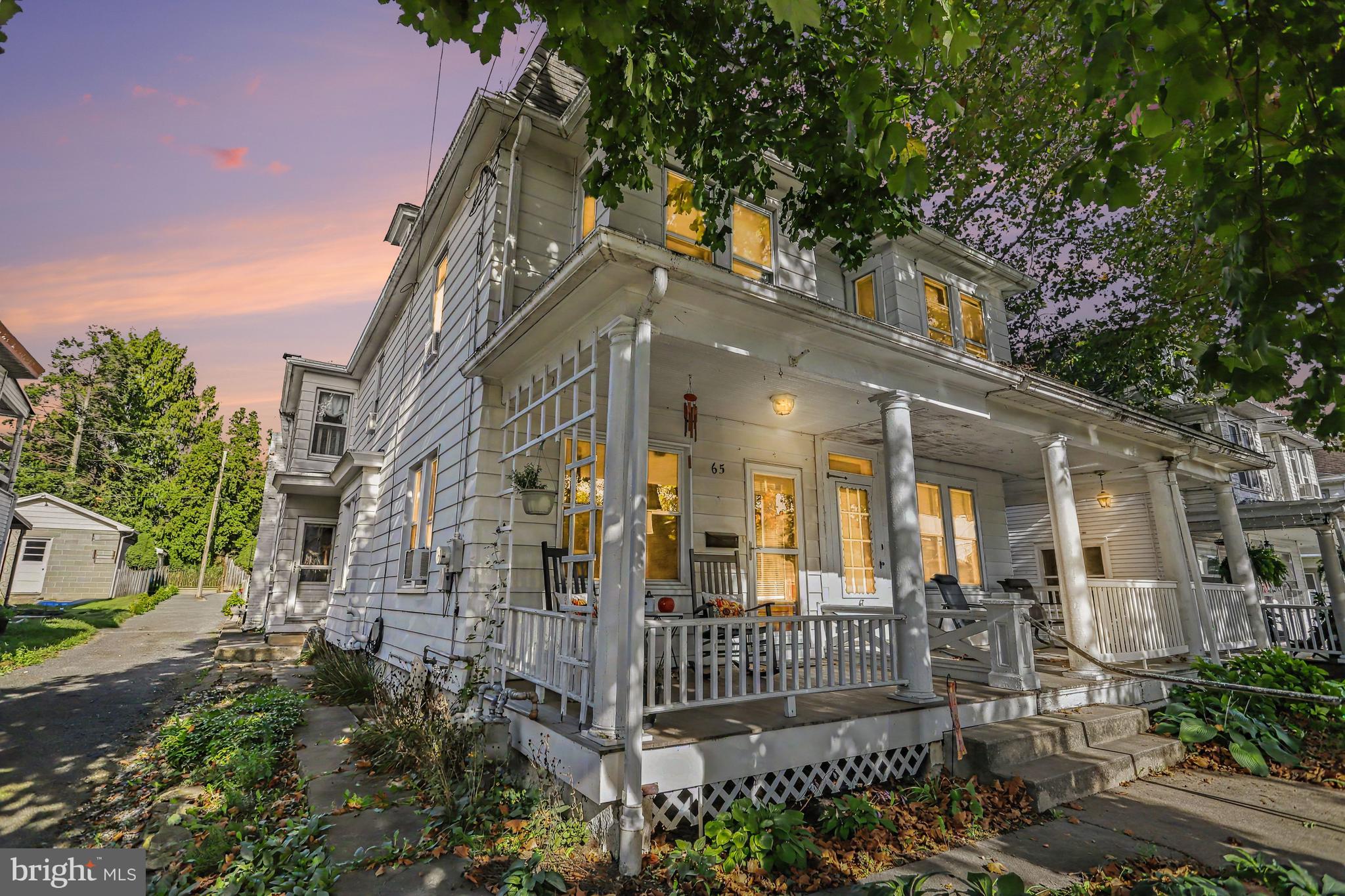 Welcome to this wonderfully maintained and stylish semi-detached duplex, where historic charm seamlessly meets modern living! This solidly built home boasts spacious rooms throughout, including a formal dining room, a generous kitchen, a convenient main-level laundry room paired with a half bath (featuring a newer stackable washer & dryer), plus a large 3-season room with plenty of windows. The heart of the home is the kitchen, featuring a newer refrigerator and dishwasher, and garbage disposal. You’ll love the large center island, perfect for meal prepping or enjoying a quick morning bite. Upstairs, you’ll find four comfortable bedrooms and a full bath featuring classic ceramic tile, recessed lighting, updated sink plumbing, and a beautifully reframed antique mirror. The primary bedroom features cozy new carpeting, built-ins, and a lighted ceiling fan. Bedroom #2 (currently used as a walk-in closet) offers direct balcony access and leads into Bedroom #3, which makes a fantastic home office, game room, or bonus space. Bedroom #4 is the entire 3rd floor and shines with fresh paint, a new rug, and its own lighted ceiling fan.  Downstairs, the partially finished lower level serves as an additional retreat, or would make a great office space; while the unfinished area provides plenty of extra storage. The home is equipped with a newer efficient hot water radiator boiler (Triangle Tube Energy Star Boiler), an electric hot water heater, a new whole-home water softener, and a professional water treatment system.  Step outside to your lovely fenced yard, complete with vibrant flower beds and a vegetable garden, plus an oversized one-car garage. You’ll love the fun and convenience of downtown living—stroll to a local café for coffee, enjoy nearby shopping, and look forward to front-row seats for the annual Halloween Parade right from your front porch! Be sure to check out the full List of Recent Improvements and Schedule your showing today!!