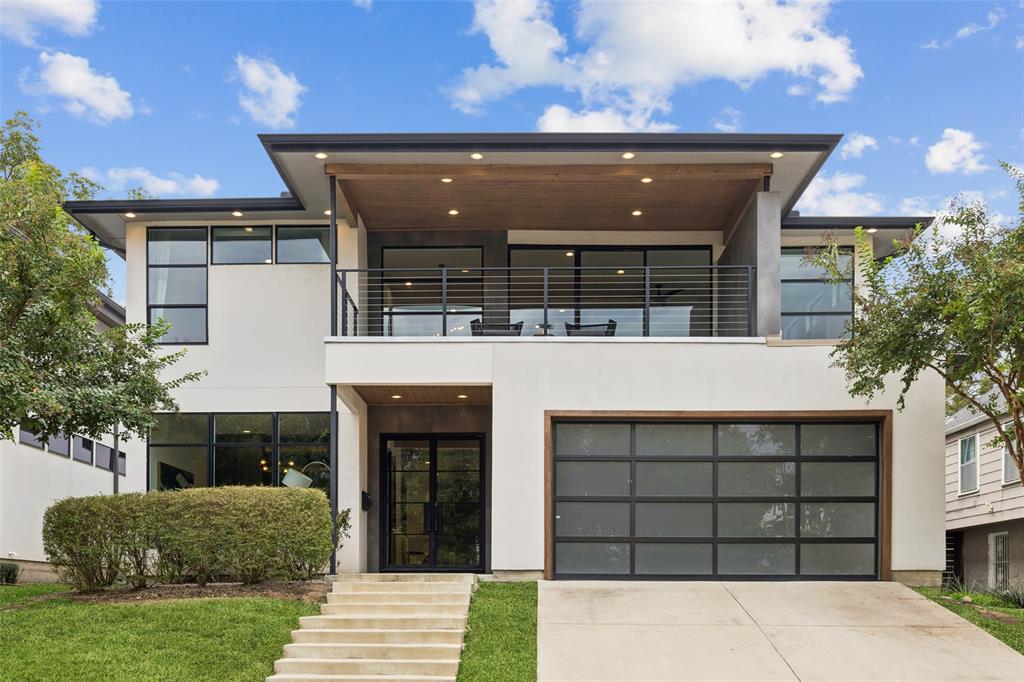 Perched on a hill in the heart of Lakewood Elementary, this newer modern home blends sophisticated design with functional living. A formal entry welcomes you into a private office with built-ins, ideal for remote work or study. The elegant dining room features an enclosed bar with a striking wine display—perfect for entertaining. The open-concept kitchen, living, and dining areas create a seamless flow, highlighted by two oversized islands, abundant cabinetry, a spacious pantry, and premium appliances including a 6-burner gas cooktop with griddle, built-in microwave, and dishwasher. The living room centers around a sleek gas fireplace and expansive sliding glass doors that open to a covered outdoor living area. The downstairs primary suite is a true retreat with a spa-like ensuite offering dual sinks, a soaking tub, a frameless double shower, and a walk-in closet with island, built-ins, and a private laundry room. Upstairs, a generous second living area with wet bar opens to a balcony and connects to a dedicated media room—ideal for movie nights or game days. Four spacious bedrooms and three bathrooms, along with an additional laundry room, complete the upper level. Outside, enjoy year-round entertaining with a built-in grilling station, gas fireplace, turfed dog run, and resort-style pool and spa. Designed for comfort, luxury, and convenience, this Lakewood stunner offers the best of modern living in one of Dallas’ most sought-after neighborhoods.
