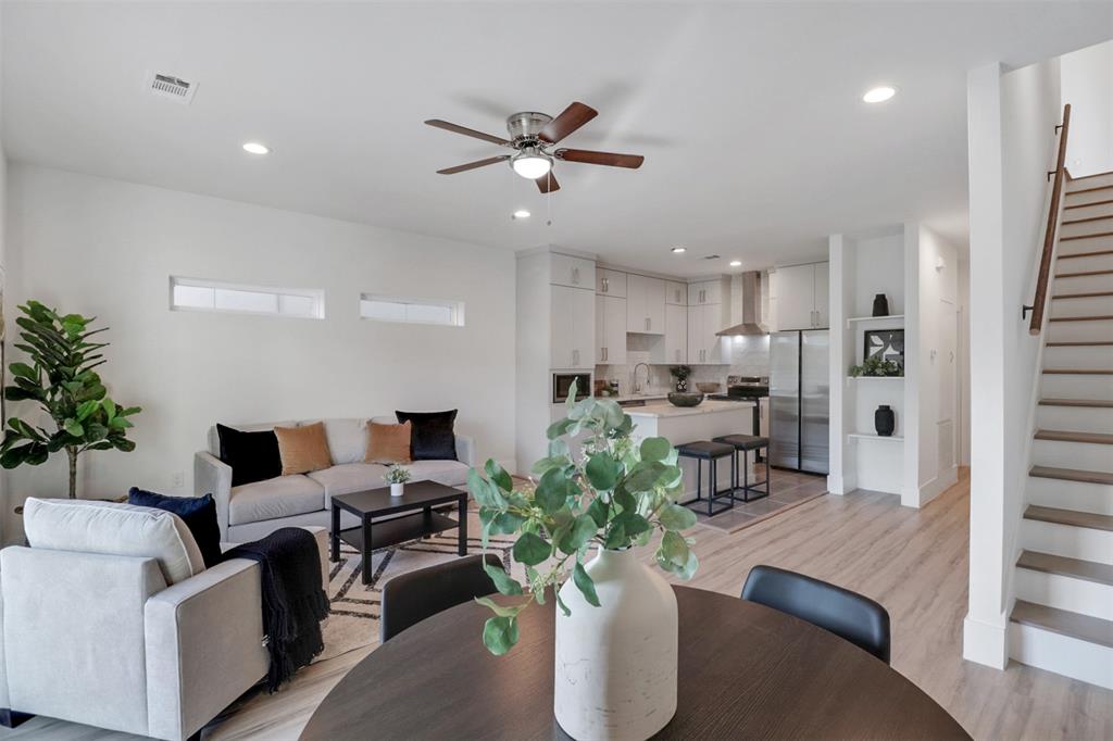 Living area featuring stairs, a ceiling fan, light wood-type flooring, and recessed lighting
