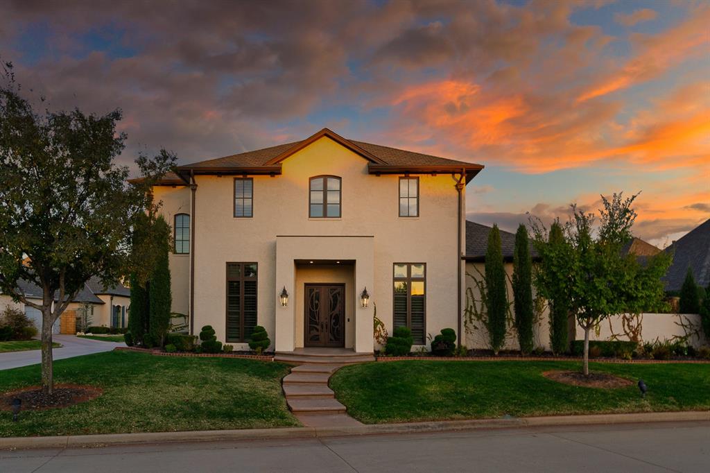 Experience refined living in Muirfield Village, one of Edmond’s most sought-after gated communities. Set on a premium, wider-than-standard corner lot, this home enjoys beautiful greenbelt views and a larger, more private yard—an advantage rarely available in the neighborhood.

A stately Mediterranean-inspired exterior, custom iron entry doors, and manicured landscaping create an elegant first impression. Inside, the main living area features high ceilings with exposed wood beams, a striking brick fireplace, and tall windows that fill the room with natural light. The spacious layout flows into a chef’s kitchen equipped with custom cabinetry, stone counters, designer tilework, a walk-in pantry, and multiple dining areas.

A private brick-arched entry leads to the study, ideal for work or reading. The primary suite is an impressive 18&#215;23 retreat, privately accessed through its own hallway and offering patio access, a spa-like bath, and a generous closet. A second en-suite bedroom is located downstairs for added flexibility. Upstairs includes another bedroom, full bath, and a large bonus room that can serve as a fourth bedroom or second living.

Outdoor living is exceptional: a beautifully designed courtyard, extensive covered patio space with multiple seating areas, and the privacy of the wider corner lot create a serene setting for relaxing or entertaining.

Residents enjoy gated entry, a clubhouse, fitness center, and resort-style pool, all within this walkable, picturesque community. Homes on premium corner lots with this level of design and privacy are rarely available—don’t miss this opportunity to experience Muirfield Village living at its finest.