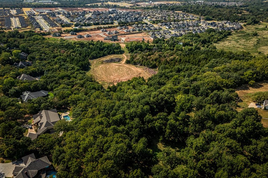 Rare opportunity to own approximately 19.76 wooded acres in one of Edmond’s growing northeast corridors near Covell Road, Air Depot Boulevard and Midwest Boulevard. Tucked behind established residential development, this unique tract offers substantial privacy and seclusion while remaining close to expanding schools, neighborhoods and community development. The property features heavy tree cover along with a cleared interior area that provides an appealing setting for a custom estate home. Purchase the full 19.76 acres or seller will consider dividing for the possibility of two large private homesites, subject to survey, applicable approvals and buyer due diligence. Nearby development includes Covell Valley, The Preserve at Covell Valley and Hidden Lake, along with the future Post Oak Elementary and Horizon Middle School campus and the future Crossings Christian Church campus at Covell and Air Depot. Access is proposed from Midwest Boulevard by permanent easement, with final easement documentation, survey if divided, and verification of access, utilities, floodplain/floodway conditions, building requirements and suitability for buyer’s intended use to be completed as part of the sale. A limited floodplain/floodway area affects the northern extension of the property. Property boundaries shown in marketing materials are approximate; buyer to verify all information important to the purchase.