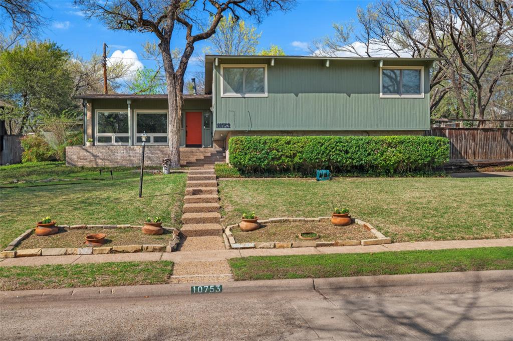 Architecurally signigant Mid-Century Modern designed by the renowned Dallas team Ju-Nel and proudly listed on the Ju-Nel register.Thoughtfully situated atop a gently rolling hill, the home was created to embrace its tranquil creek view & lush natural surroundings. Mature trees & a serene setting create a sense of private retreat. Inside, authentic MCM character remains beautifully intact. Original wood & brick floors anchor the living  spaces, while the striking original fireplace serves as a timeless focal point. Expansive windows capture abundant natural light & frame the peaceful views of the surrounding landscape. The kitchen is a striking, featuring a vibrant red sink & dramatic red accent lighting overhead. An unforgettable space that blends vintage personality with everyday funtionality. While the extent of the original kitchen features is unknown, the design remains both bold & captivating. Generously proportioned rooms provide comfortable living & entertaining spaces, complemented by abundant storage throughout. The home sits on .295 acre. Located just minutes from White Rock Lake the home enjoys convenient access to one of Dallas’ most beloved outdoor destinations for walking, cycling, and nature. An oversized garage offers exceptional flexibility with ample space for a workshop, gym, hobby studio, or additional storage. A rare opportunity to restore and refine a true architectural gem, preserving the integrity of a Ju-Nel design while bringing new life to a remarkable Mid-Century Modern home.