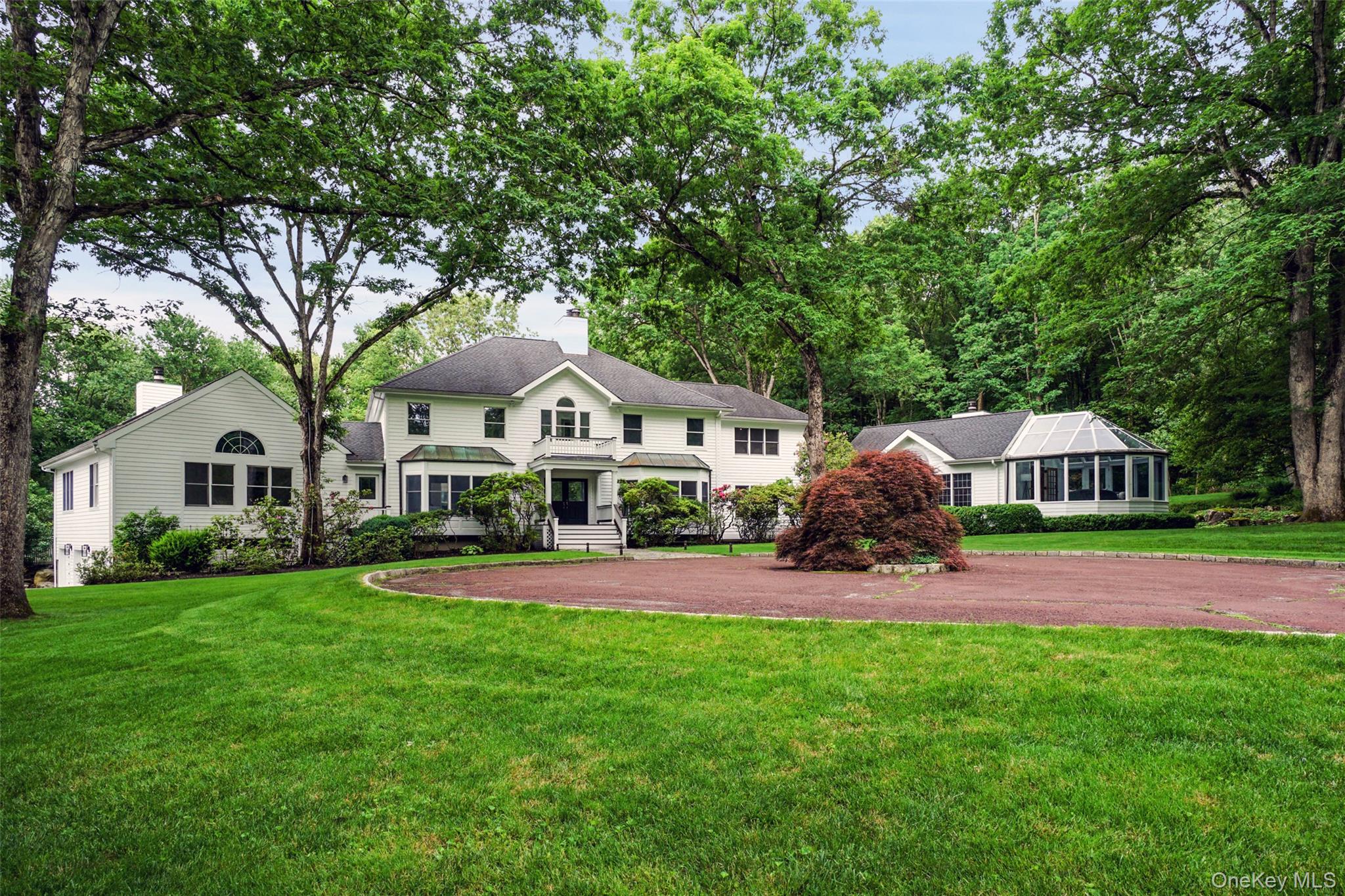 Prime Bedford gated estate on over 15 glorious acres of open, level land with spectacular age old specimen trees. This property is totally private, quiet and is less than 3 minutes to town. It was renovated from top to bottom in 2022 with everything new including kitchen and all baths.  The house has a perfect floor plan with gracious formal and family spaces for entertaining inside and out. It includes a beautiful wood paneled library/office with a private entrance, dramatic heated glass conservatory, screened porch with plexiglass panels, a heated gunite pool as well as your own squash court!  The first floor guest suite is perfectly tucked away and the finished lower level is multi-purpose. Full house generator. Taxes have been grieved and assessment will be reduced significantly.