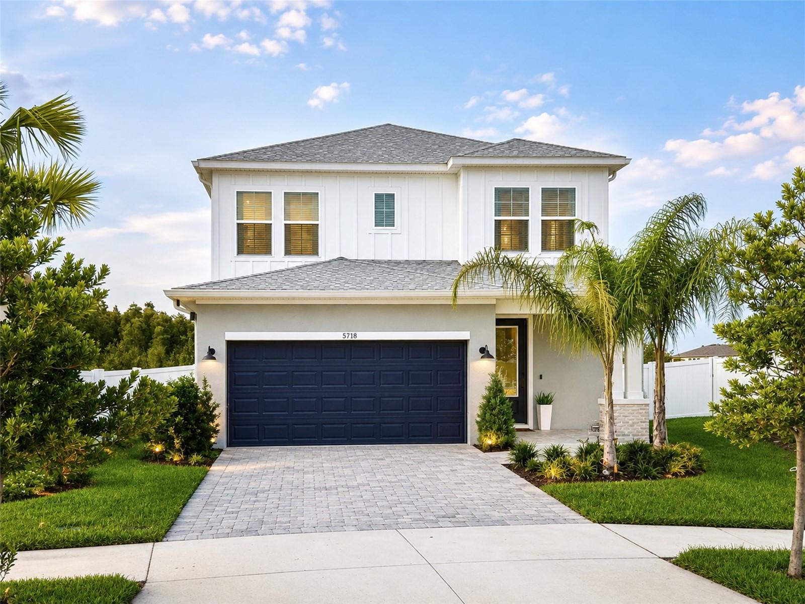 Beautifully designed and exceptionally private, this 2,411 sq. ft. David Weekley home offers 4 bedrooms, 3 baths, a flexible two-story floor plan, and an oversized pie-shaped backyard tucked away on a quiet cul-de-sac. The fully fenced yard backs to peaceful conservation and mature trees with no rear neighbors, creating a wonderfully quiet and private setting.Inside, the modern farmhouse design is complemented by approximately 10-foot ceilings and a bright, open living space. The kitchen features custom light oak-style cabinetry, quartz countertops, a pot filler, and plenty of space for gathering and entertaining. A whole-house water filtration system with easy-change cartridges and separate 5-stage reverse-osmosis drinking water system add everyday convenience.The first-floor primary suite is privately positioned at the rear of the home overlooking the backyard. A centrally located den/office offers flexible space for a fourth bedroom, home office, or guest room. Upstairs you'll find two additional bedrooms and a spacious bonus loft—ideal for a second living area, playroom, media room, or additional workspace.Outdoor living is a standout feature. The fully screened covered lanai includes a custom outdoor kitchen complete with a Blackstone Professional Series cooktop, pizza oven, refrigerator, and sink. Beyond the lanai, the expansive pie-shaped backyard provides plenty of room to entertain, play, garden, or simply enjoy the wooded conservation views.Additional features include a deep two-car garage offering excellent parking and storage space, a dedicated laundry room with front-load washer and dryer and custom built-in shelving, a smart-home package, and an owned security system.Enjoy resort-style community amenities including a pool with lazy river, fitness center, community and office space, pickleball courts, playground, dog park, and miles of walking trails—including scenic trails around a beautiful lake.A rare combination of privacy, thoughtful design, flexible living space, exceptional outdoor living, and resort-style amenities in Wesley Chapel. Some photos may be AI-enhanced.