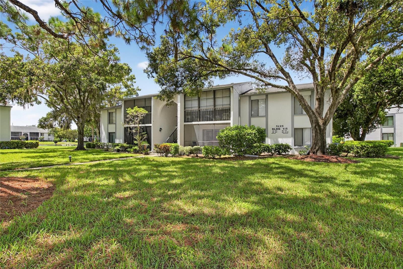 Welcome to Pine Ridge at Lake Tarpon, a beautifully maintained, non-age-restricted, resort-style community perfectly situated in the heart of the East Lake Corridor! Flanked by the serene Brooker Creek Preserve to the east and picturesque Lake Tarpon to the west, this neighborhood offers the perfect blend of nature and convenience. Enjoy close proximity to top-rated schools, shopping, dining, hospitals, a library, and more—with Honeymoon Island just 30 minutes away and Tampa International Airport only 20 miles from your door.

This move-in-ready, second-floor condo features 2 spacious bedrooms and 2 full bathrooms with a bright, open-concept layout. Inside, you’ll find new luxury vinyl flooring in the kitchen, living, and dining areas, plus durable tile in the bathrooms. The kitchen offers ample cabinet space, a refrigerator, range, microwave, and convenient breakfast bar pass-through for casual dining or entertaining. The generously sized primary suite boasts a walk-in closet and en-suite bathroom with a walk-in shower, while the second bedroom is equally spacious—both enjoying tranquil pond views.

Step out to your private, covered, screen-enclosed patio and take in peaceful water views, daily wildlife visits, and the lush preserve—your perfect Zen retreat. Additional highlights include in-unit laundry with a stackable washer/dryer and plenty of storage.

Residents of Pine Ridge enjoy resort-style amenities including a heated pool, spa, clubhouse, tennis courts, shuffleboard, and a playground. With so much to offer in an unbeatable location, this condo is the perfect place to call home!