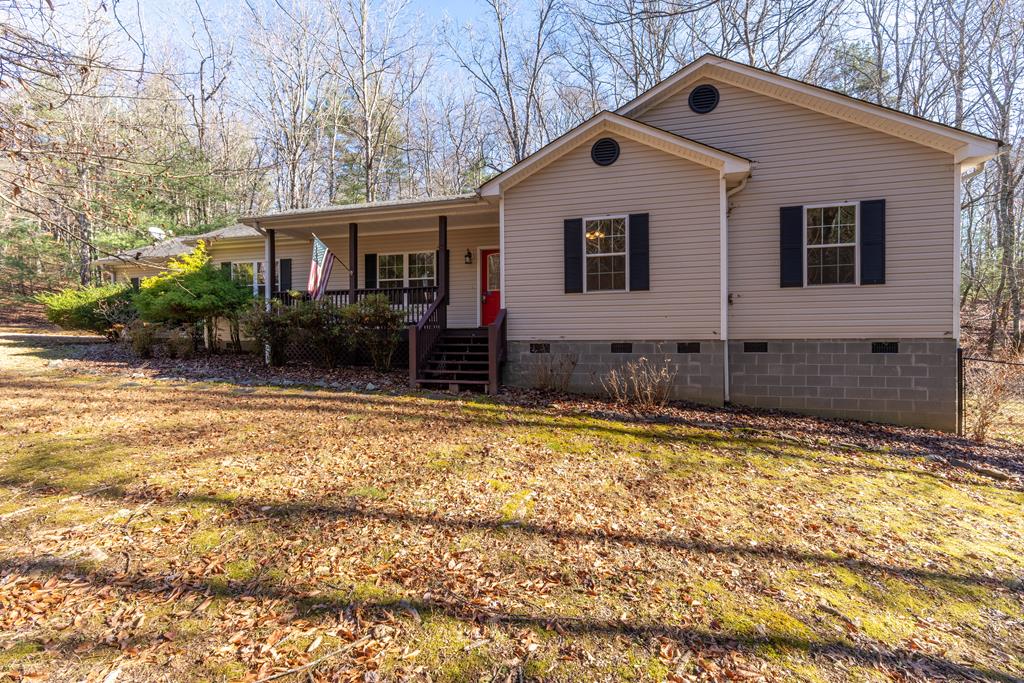 Your Mountain Sanctuary Awaits at 228 Goldfinch Ln, Murphy NC. Step into the perfect blend of comfort, nature, and modern living in the highly sought-after Country Mountain Ridge Community. This charming 3 bedroom, 2.5 bath home with a dedicated study offers everything you've been dreaming of — and more. Nestled on a beautifully level 1.05-acre lot, this property delivers privacy, peacefulness, and your very own stream where local wildlife loves to gather. Imagine sipping morning coffee while deer wander by, or listening to the sound of running water as the sun sets. It's mountain living at its finest. Inside, the home features a warm and welcoming layout with spacious living areas, abundant natural light, and room for everyone to spread out. A double-car garage provides convenience and extra storage — and the perks don't stop there Outside, the property shines with a chain-link fenced yard perfect for your fur babies to run, play, and stay safe. You'll also love the additional utility building, ideal for a workshop, art studio, hobby space, she-shed, or extra storage — opportunities like this are rare. Entertaining is effortless on the brand-new deck, complete with a retractable awning so you can enjoy outdoor gatherings in any weather. Host cookouts, listen to the creek, watch the fireflies, or unwind under the stars — this space was made for making memories. Key Features You'll Love:  3 Bedrooms, 2.5 Baths + Study  Double-Car Garage  Chain-Link Fenced Yard for Pets  Additional Utility Building (Workshop/Studio/Flex Space)  Level 1.05-Acre Lot  Beautiful Stream with Abundant Wildlife  NEW Deck + Retractable Awning  Located in Lovely Country Mountain Ridge Community  Peaceful, Private, and Move-In Ready Homes like this — with land, water, usable outdoor space, fenced yard, and extra buildings — don't come along often. If you're looking for mountain serenity with modern conveniences, this is the one you've been waiting for.  Schedule your showing