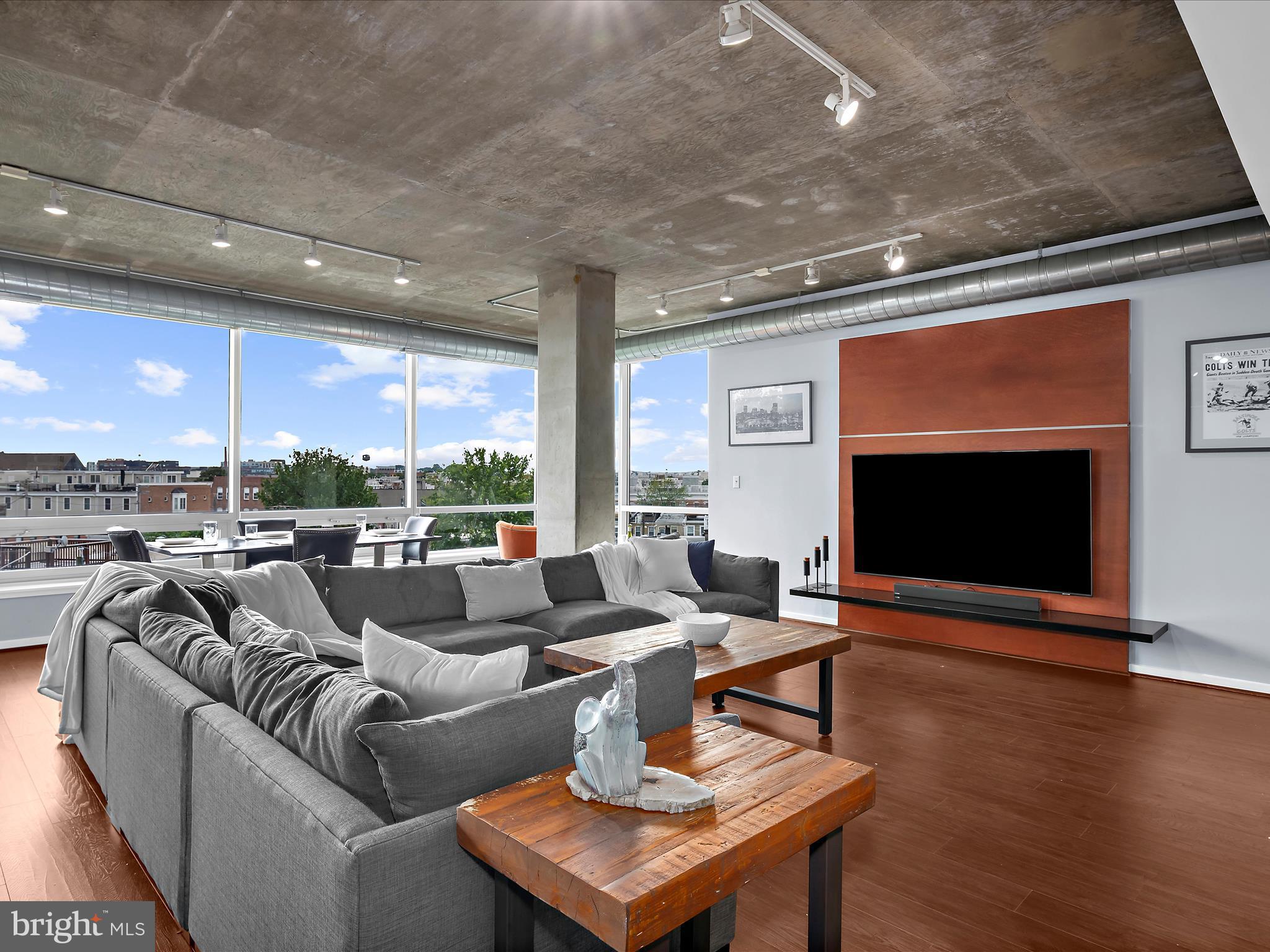 Welcome to the largest one-bedroom, one-and-a-half-bath residence at Silo Point. This spacious 1,590 square foot corner unit offers unmatched privacy, abundant natural light, and sweeping panoramic views stretching from north to west and south. Enjoy stunning sunsets, city skyline vistas, cruise ship activity, and seasonal fireworks all from the comfort of your living space.The gourmet kitchen is thoughtfully appointed with a 2025 Whirlpool French-door refrigerator and freezer, a Frigidaire microwave, stove, and dishwasher (all new in 2022). Updated countertops, a new sink, and faucet, and a striking waterfall-edge island create a modern, functional focal point. Upgraded wood flooring and new carpet installed in December 2024 add warmth and refinement throughout.The spacious primary suite features a walk-in closet and a spa-style bathroom with dual vanities, new faucets, a soaking tub, and a separate glass-enclosed shower. Both the primary and guest bathrooms have been updated with new toilets for added comfort and efficiency.Additional features include in-unit laundry, two deeded garage parking spaces, and generous storage throughout.Silo Point residents enjoy a full suite of amenities, including a state-of-the-art fitness center, yoga studio, game and conference rooms, and the exclusive 19th-floor Sky Lounge with breathtaking harbor and city views. The building also offers 24-hour front desk service, secure entry, bike storage, and a pet-friendly atmosphere.Located in the heart of Locust Point near Fort McHenry and the Baltimore Peninsula, Silo Point offers convenient access to commuter routes, water taxi stops, public transportation, and major highways. Downtown Baltimore, Federal Hill, Camden Yards, and an array of dining, retail, and parks are all nearby. BWI Airport is less than 20 minutes away, offering easy access to Washington, D.C.This home presents a rare opportunity to enjoy generous square footage, modern updates, and a front-row seat to Baltimore’s waterfront and skyline.