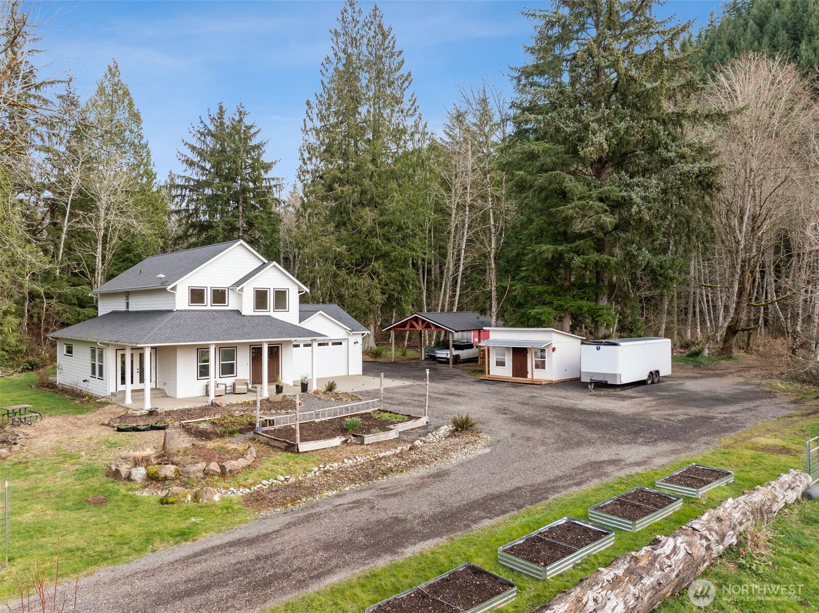 Absolutely incomparable- this breathtaking estate is tucked into an incredibly private, storybook setting along Coal Creek. With over 1,000 feet of pristine creek frontage and 6.14 serene acres, the property offers unmatched natural beauty and tranquility.The expansive grounds present an extraordinary opportunity for a private wedding or exclusive event venue, where celebrations unfold against a backdrop of flowing water and lush landscape.The home welcomes you with a large covered front porch, ideal for enjoying peaceful mornings and sunset views. Inside, you'll find a grand double-door entry, soaring ceilings, hardwood floors, and expansive windows that fill the home with natural light & showcase the surrounding scenery. Stunning white and bright kitchen with quartz island. A fully finished workshop/shed provides flexible space for hobbies, storage, creative projects or business use. Thoughtfully wired for a generator for added security. A rare blend of privacy, beauty, and potential—this is creekside living at its finest.