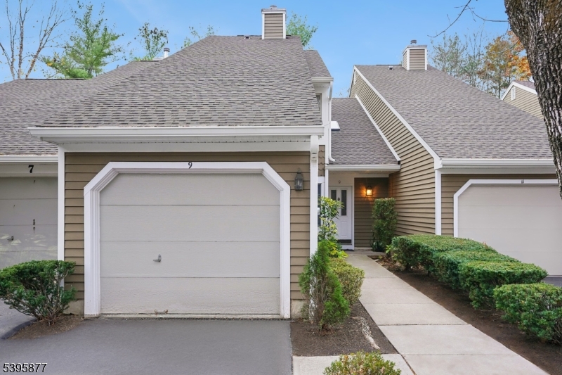 Welcome to this inviting townhouse in the desirable Hills community. This move-in-ready home features a renovated kitchen with granite countertops, a dining room, and a spacious living room with a fireplace, built-in shelves, and sliding doors that open to a private patio overlooking a generous common green space. A half bathroom and an attached garage complete the main level. Upstairs, the large primary bedroom offers a fully renovated en-suite bathroom and hardwood floors. A second bedroom with its own full bathroom adds comfort and flexibility, with laundry conveniently located on the same level. A skylight brightens the hallway, enhancing the home's natural light and welcoming feel. Ideally situated, this property is just minutes from River Road Park, the Great Swamp National Wildlife Refuge, and Hacklebarney State Park, offering easy access to outdoor recreation and the best of Bedminster living.