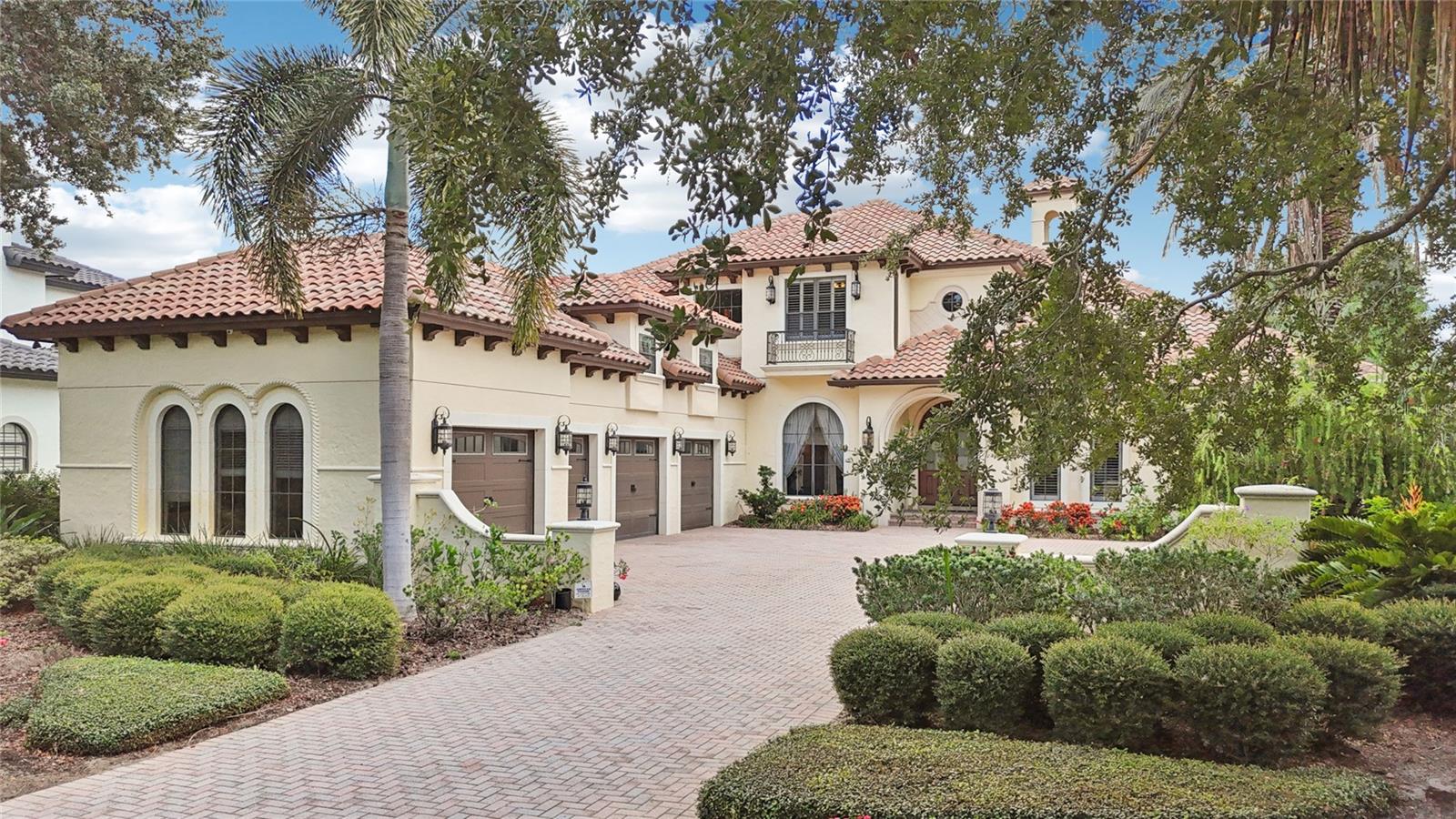 Under contract-accepting backup offers. Welcome to 9253 Tibet Pointe Circle in the beautiful 24-hour gated/guarded community of Keene's Pointe in Windermere, Florida.  This elegantly timeless JR Watson custom-built mediterranean style home located on over 224 feet of lake frontage on Lake Tibet of the Butler Chain of Lakes, offers a functional and spacious floor plan to accommodate any buyer.  Entering the drive up to the courtyard is a 4-car garage and inviting entrance with wood and glass arched doors.  The formal living room with gas fireplace and private dining room pave the way to the kitchen with large breakfast bar, island, walk-in pantry and high end appliances, overlooking the great room with wood beamed ceiling and sliding pocket doors, as well as a wet bar, wine cellar and spacious laundry and mud area.  On the other side is the private primary suite with large walk-in closet and spacious primary bath, as well as a functional office with built-ins and wood beamed ceiling.  The second floor boasts a bonus area half way up the wood and iron staircase, perfect as a media or exercise room or additional office or hobby room. At the top of the stairs is an open area with built-in desks for study time, three spacious en-suite bedrooms and a game room with wet bar that opens up to the balcony overlooking the back yard and lake.  Perfect for entertaining the 10 ft. multi slide pocket doors in the family room open up to the lanai to create a seamless transition between indoor and outdoor space to the outdoor lanai large enough for another complete living area with summer kitchen and its own gas fireplace overlooking the pool with rock waterfall and spa.  Just outside the screened enclosure is the fire pit with an abundance of seating, fenced back yard and walk way to the boat dock.  This home boasts 12 ft. ceiling throughout with exquisite architectural details, and has been lovingly attended to with new sod, new pool equipment, smart home features such as Sonos, Lutron lighting, MyQ, smart thermostats, security and camera systems, updated AC units, newer Sub Zero and Wolf appliances, hardwood flooring, plantation shutters, and much more!  Conveniently located to top-rated public and private schools, shopping, dining, expressways and tourist attractions.  This beautiful lakefront estate is priced to sell, call today for your private viewing.