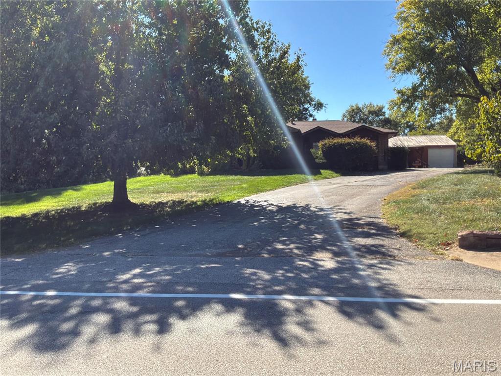 Country living on 1.092+/- sloped up/LEVEL Acres STUNNING acres in desirable, PRIME CHESTERFIELD LOCATION along Schoettler Road. It is truly a "diamond in the rough". CHARMING, RANCH home with 2 bedrooms, 2 baths, 2 bonus rooms & 2,614+/- SqFt of living space that offers an AWESOME, 40’ x 30’, 2-car, detached garage/metal outbuilding! Covered front porch greets you as you step inside the dining/breakfast room with job-finished wood flooring & bay window. Step down/sunken living room boasts a floor-to-ceiling brick gas fireplace, carpet flooring, 11’+/- tray ceiling w/wood beams & walk-out to deck. Kitchen features wood railing overlooking the living room, custom cabinetry, tile backsplash, granite, center island, walk-out to deck & garden window above sink allowing plenty of natural light. 2 Bedrooms with job-finished wood flooring, slide closets, ceiling fans & share hall bath with a shower/tub w/sliding glass doors & a single sink vanity. Walk-out lower level extends living quarters with 7’+/- ceilings, laundry room, rec room, full bath & 2 bonus rooms. Outdoors, one will enjoy a level backyard with a tree line, partially covered porch & gazebo. Within the Parkway School District w/easy access to HWY 64/Olive Blvd/Clarkson Rd/Clayton Rd, shopping, dining & Chesterfield amenities. MUST SEE! Listing includes 2 parcels: (1421 Schoettler Road) - Tax ID: 19S-64-0196 & (1435 Schoettler Road) - Tax ID: 19S-64-0206. THIS LISTING IS DUPLICATE OF MLS #26064615.