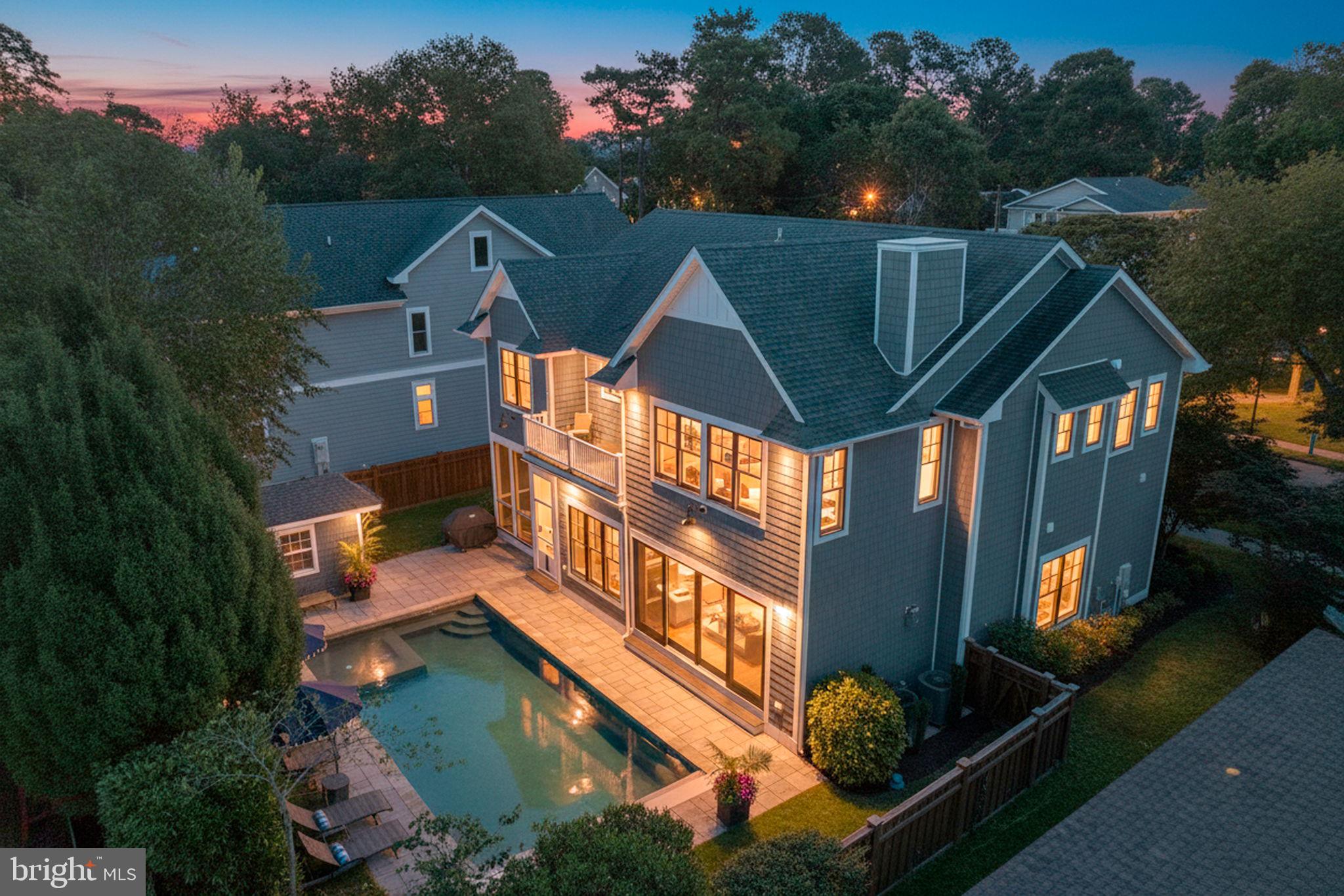 South Rehoboth Coastal Elegance – Unparalleled Luxury & LifestyleExperience the pinnacle of coastal living in this extraordinary Garrison-built residence, ideally situated just one and a half blocks from the Atlantic in South Rehoboth Beach. With 3,960 square feet of meticulously designed interior space on a 75-by-100-foot lot, this home offers an unmatched combination of sophistication, comfort, and elegance—an in-town opportunity that cannot be duplicated under current zoning regulations.The exterior embodies timeless luxury with professional landscaping, exterior lighting, and a full irrigation system. An oversized heated gunite pool with electric cover serves as the centerpiece of outdoor entertaining, complemented by screened front and rear porches that provide serene retreats to enjoy the meticulously maintained grounds in complete privacy.Inside, the home impresses immediately with soaring 10-foot ceilings, rich oak flooring, solid wood doors, and plantation shutters throughout. The great room, centered around a gas fireplace and custom built-ins, flows seamlessly into the gourmet kitchen. Designed for both casual and refined entertaining, the kitchen features a Wolf six-burner range, oversized Sub-Zero refrigerator/freezer, quartz countertops, and a generous island. A wet bar with wine refrigerator and whole-home audio elevate the space, while the central vacuum system adds effortless convenience.Two first-floor ensuite bedrooms provide private accommodations for guests or multigenerational living, each appointed with luxurious baths. Every closet throughout the home is professionally finished with organizational shelving and lighting that illuminates upon opening, reflecting unparalleled attention to detail.The second-floor primary suite is a private retreat, complete with a fireplace, expansive California-closet-style dressing room, and a spa-inspired bath with heated floors, freestanding soaking tub, and a walk-in shower with multiple shower heads including a rain feature. A private second-floor deck overlooks the rear yard and pool, offering a tranquil vantage point for morning sunrises or evening relaxation. Additional bedrooms on this level continue the theme of refined design, with most baths featuring heated flooring.This home features six bedrooms, five-and-a-half baths, two fireplaces, and a 1,931-square-foot unfinished basement, providing extraordinary scale and versatility. Every detail has been carefully curated—from ceiling fans and alarm systems to built-ins and integrated technology—creating an environment where modern convenience meets timeless elegance.Outdoor living is equally exceptional. The heated gunite pool anchors a beautifully landscaped yard, perfectly complemented by the rear screened porch for seamless indoor-outdoor enjoyment. Professional landscaping, exterior lighting, and irrigation maintain a pristine setting year-round, ideal for entertaining or private enjoyment.Located just steps from the beach, Rehoboth’s iconic boardwalk, fine dining, boutique shopping, and nearby walking and biking trails, this home offers the ultimate coastal lifestyle. Despite its proximity to vibrant downtown attractions, the property maintains privacy and tranquility, creating a rare combination of accessibility and seclusion.This Garrison-built masterpiece delivers a luxury lifestyle defined by scale, craftsmanship, and refined design. From the heated pool to the gourmet kitchen, spa-inspired baths, private decks, and expansive basement, every element has been crafted to provide comfort, elegance, and the ultimate South Rehoboth Beach experience.A rare opportunity to own a residence where elegance, location, and coastal lifestyle converge in a home that cannot be duplicated.