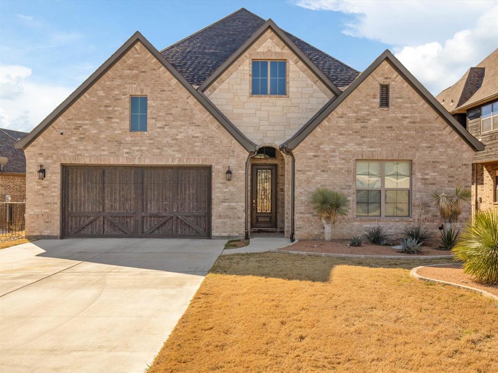 Golf course living meets lakeside luxury in this stunning 2019-built home, perfectly positioned on the 9th hole of the premier championship course at The Resort on Eagle Mountain Lake. This 3,245 sq. ft. residence offers a front-row seat to the manicured greens and is just moments from private community boat ramps and lakeside amenities. The open-concept floor plan is designed for seamless entertaining, featuring soaring vaulted ceilings and a gourmet kitchen equipped with a 5-burner gas cooktop, double ovens, and a custom beverage center with a built-in wine cooler. Retreat to the primary suite, a private sanctuary with a spa-like ensuite and expansive walk-in closet. A dedicated study with elegant French doors provides the ideal home office. Outdoor living is a standout feature, with a covered back patio and a second-story balcony offering unobstructed fairway views and refreshing lake breezes. As part of a 24-hour guard-gated community, residents enjoy an unparalleled lifestyle with access to a private clubhouse, fitness center, resort-style pool, and exclusive Eagle Mountain Lake access including a private beach and playground. The oversized 3-car garage includes dedicated space for a golf cart, workshop, or lake toys. Energy-efficient features include a 16+ SEER AC, low-E windows, and a radiant barrier for low utility costs. Professional landscaping, a full sprinkler system, and a wrought-iron fence complete this exquisite exterior. Enjoy fine dining at the onsite clubhouse restaurant or a sunset boat cruise, all within minutes of your front door. This property offers modern sophistication and resort-style relaxation just minutes from the heart of Fort Worth and the Stockyards.