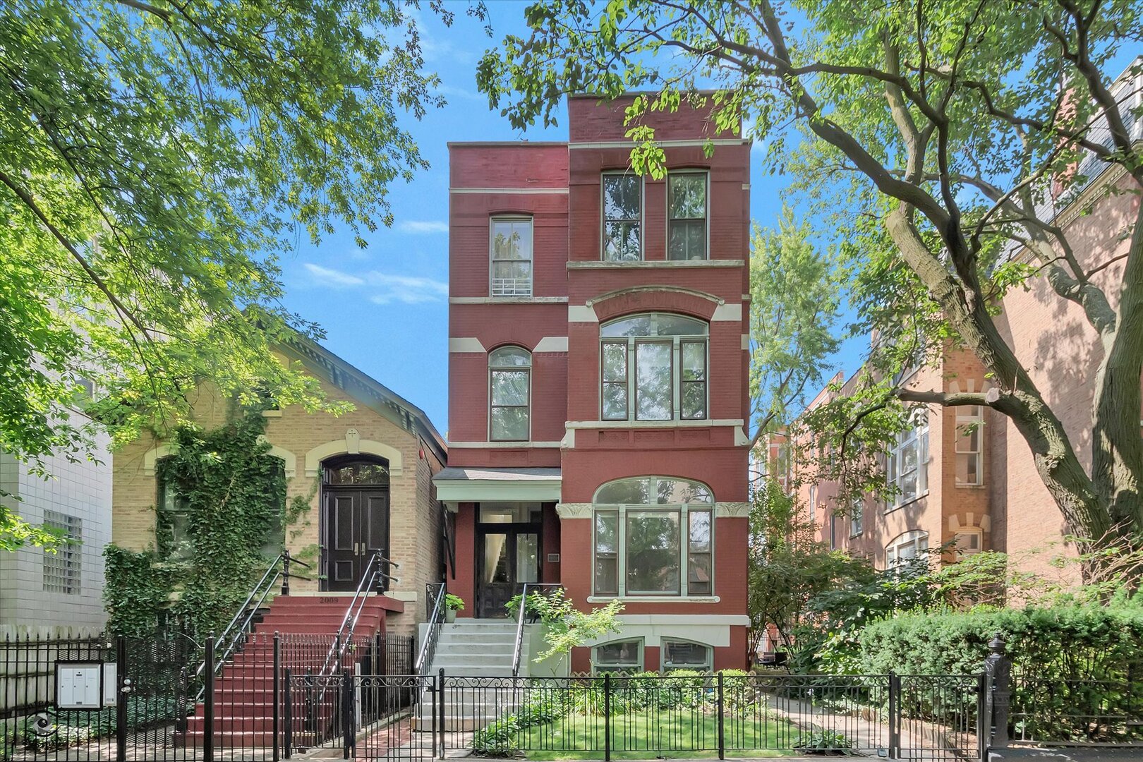 Located in the heart of Wicker Park, this beautiful, light-filled vintage home is full of charm and ready for your personal touch.    Boasting approximately 2,200 sq.ft., the open floor plan offers three spacious, connected living areas, bathed in natural light from a large front bay window and expansive west-facing windows overlooking an open yard. Soaring 13-foot ceilings, a natural wood-burning fireplace,  and vintage crown molding add timeless character and warmth.    The chef's kitchen features granite countertops, a breakfast bar, 42" cabinets, and stainless steel appliances-perfect for entertaining. Just off the kitchen, a laundry room, a powder room, convenient rear foyer, and a private deck leading to the garage and common yard.    Enjoy two generous bedrooms, including a primary suite with walk-in closet, separate shower, and ensuite bath. The second bedroom offers a custom closet and access to another full bath. Additional highlights include ample storage, custom built-ins, and a second mudroom.    Relax on the welcoming front porch and take in the vibrant neighborhood scene-just one block from Division Street, a half block to Wicker Park, and four blocks to Bucktown's lively Six Corners. Garage parking included. Nestled on the border of two of Chicago's most sought-after neighborhoods.