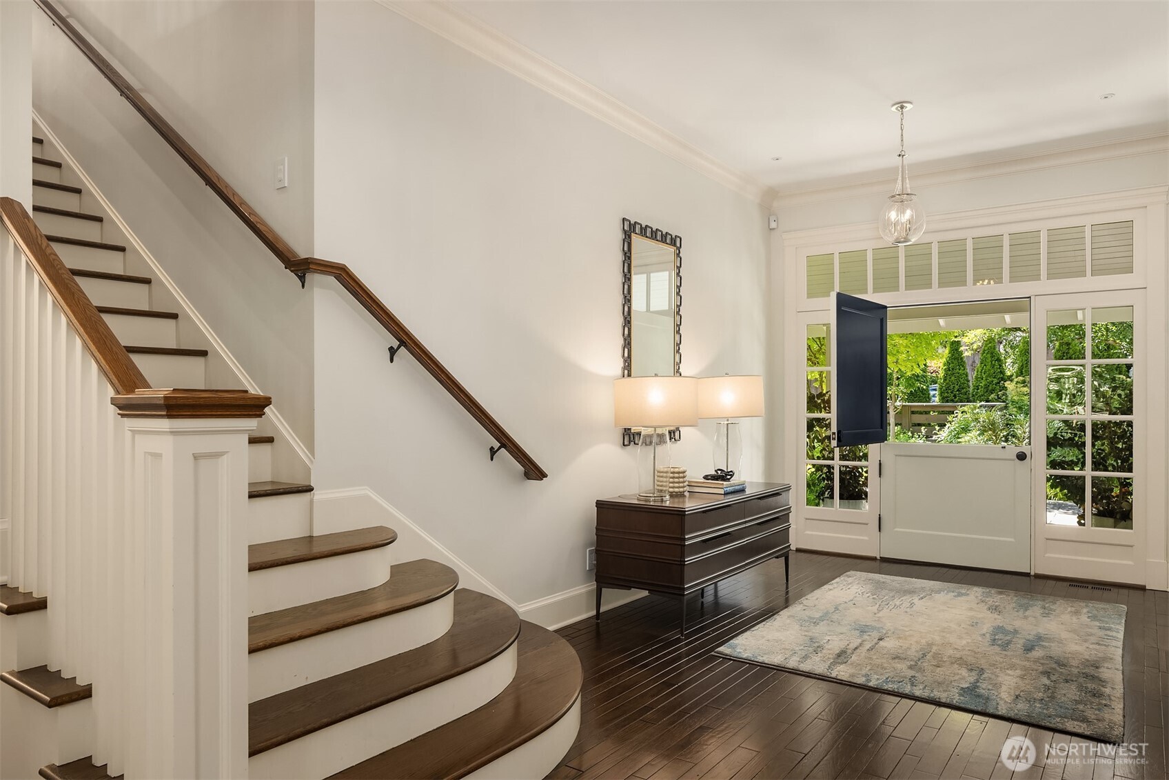 Grand entry foyer with a graceful curved staircase