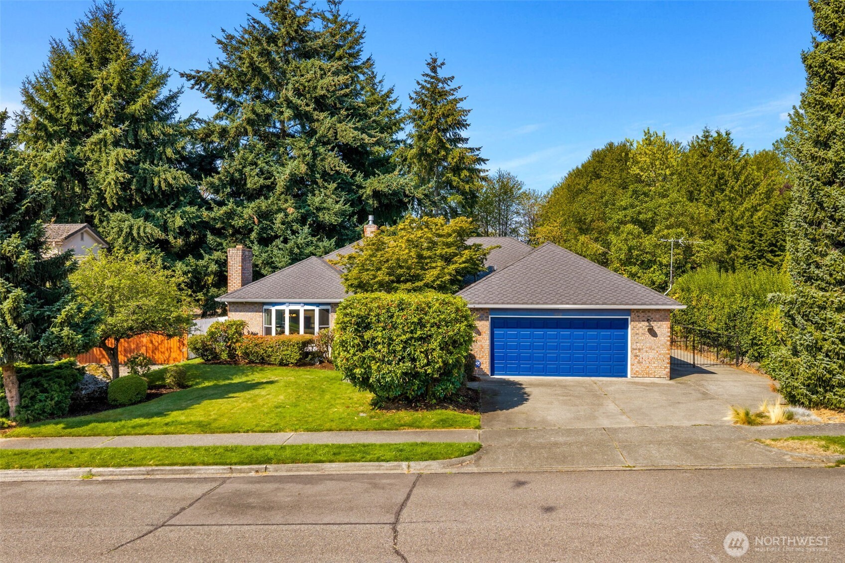 Spacious North Shore/Browns Point rambler with an approximately 500 sq ft detached SHOP/garage, plus an attached garage, all on a beautifully landscaped .30-acre lot! This 1,906 sq ft, 3-bedroom home offers comfortable single-level living in a quiet neighborhood, with vaulted ceilings, skylights and an open, light-filled floor plan. Distinctive brickwork surrounding the gas fireplace creates a warm focal point in the heart of the home. Generous living spaces and a primary suite with private bath and walk-in closet. Outside, enjoy privacy with a large deck, fully fenced yard, mature landscaping and fruit trees. The detached shop offers room for at least two cars, an RV or boat, with additional parking for even more flexibility. Heat pump provides year-round comfort, complemented by a 50-year-rated composition roof. Excellent North Shore/Browns Point location with elementary and middle schools nearby, golf just blocks away and beautiful Norpoint Park close by. Convenient to downtown Tacoma with easy access to the new Federal Way light rail station. A rare combination of single-level living, generous lot, substantial shop and outstanding location.